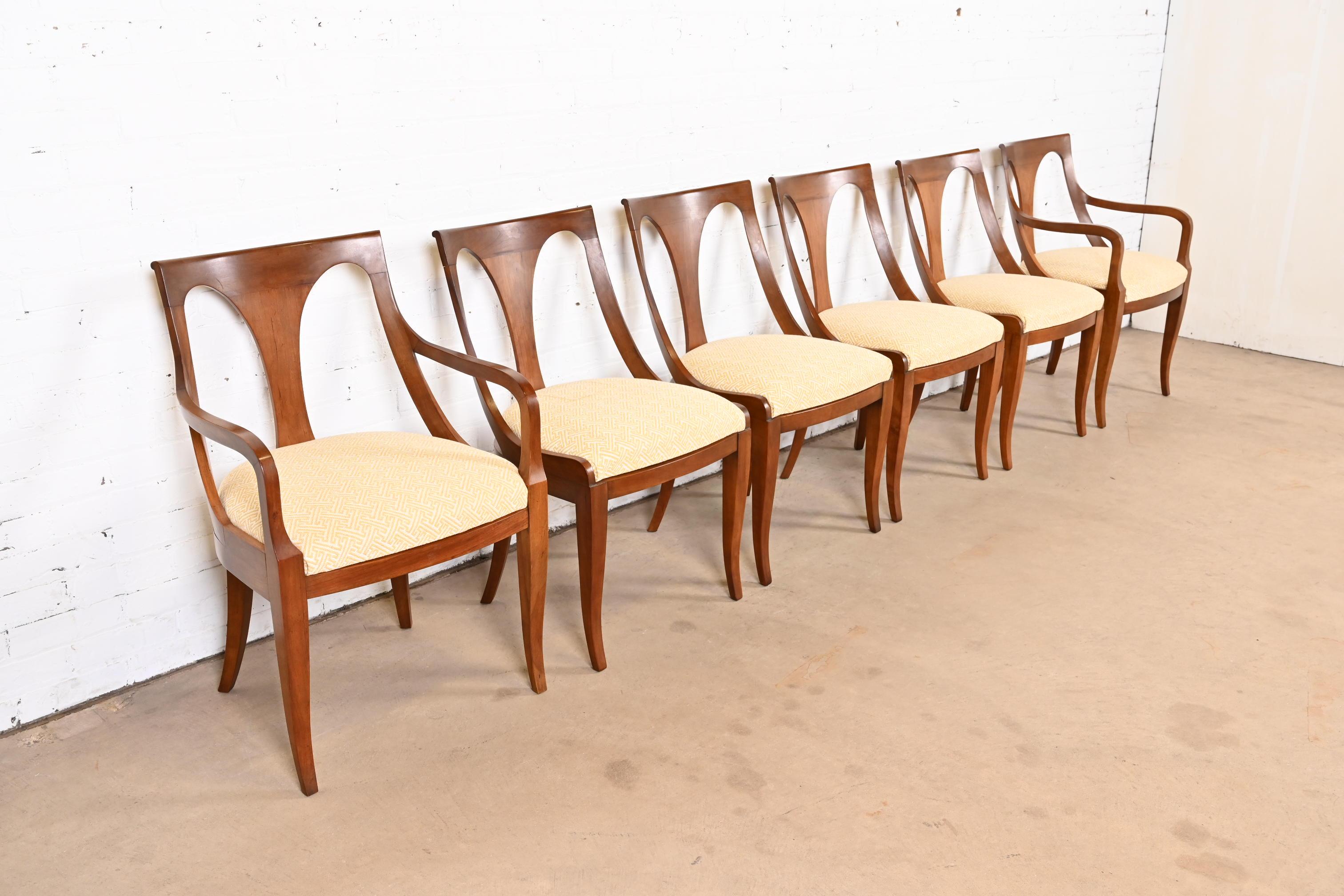A beautiful set of six Regency or Neoclassical style dining chairs

By Kindel Furniture

USA, Circa 1960s

Solid cherry wood frames, with upholstered seats.

Measures:
Side chairs - 19