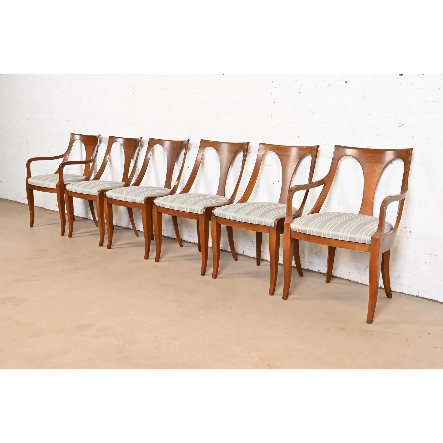 A beautiful set of six Regency or Neoclassical style dining chairs

By Kindel Furniture

USA, Circa 1960s

Solid cherry wood frames, with upholstered seats.

Measures:
Side chairs - 19