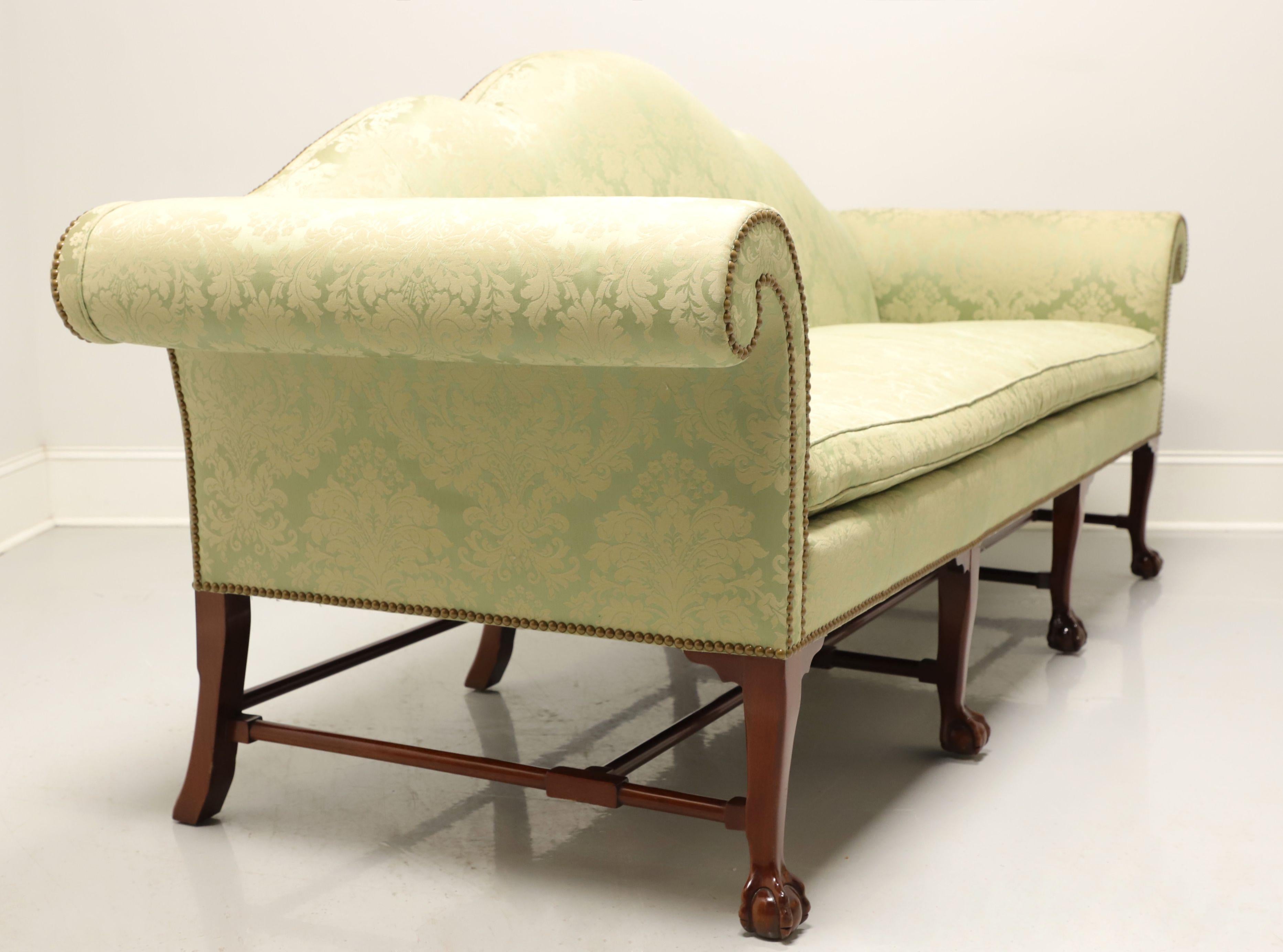 A reproduction of an 18th Century Georgian style camel back sofa by Kindel Furniture, from their Irish Georgian Collection. Mahogany frame, camel back, rolled arms, single reversible seat cushion, brass nail head trim, stretcher base and four front