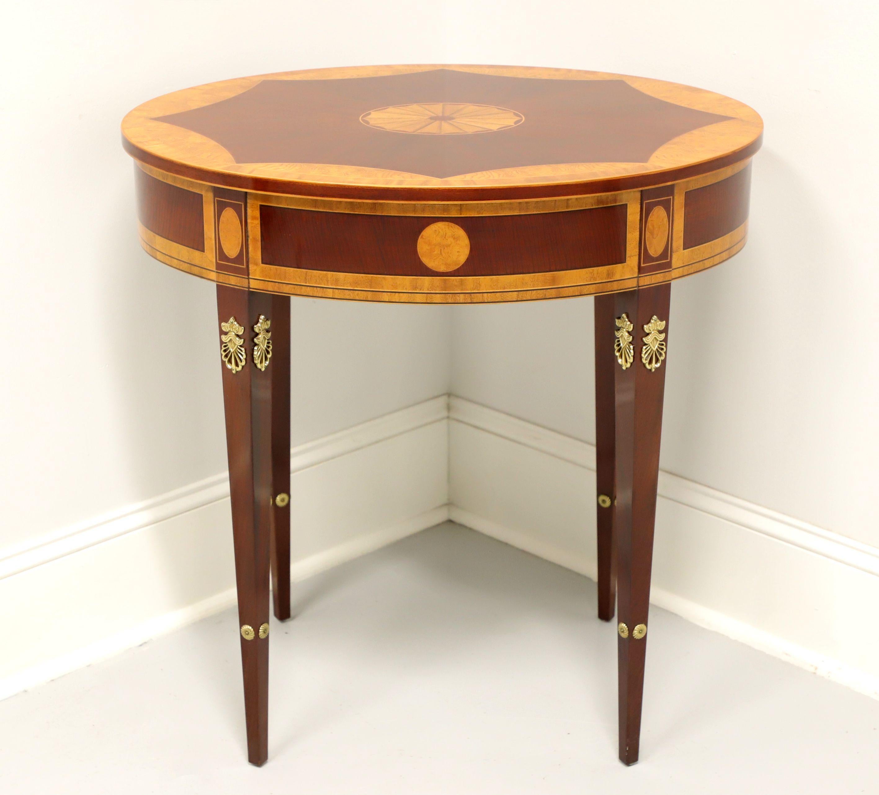 An authorized reproduction of an 18th Century Georgian style oval occasional table by Kindel Furniture, from their Irish Georgian Collection, the original being at Winterthur Museum. Mahogany with inlays of burlwood & satinwood, banded & inlaid top,