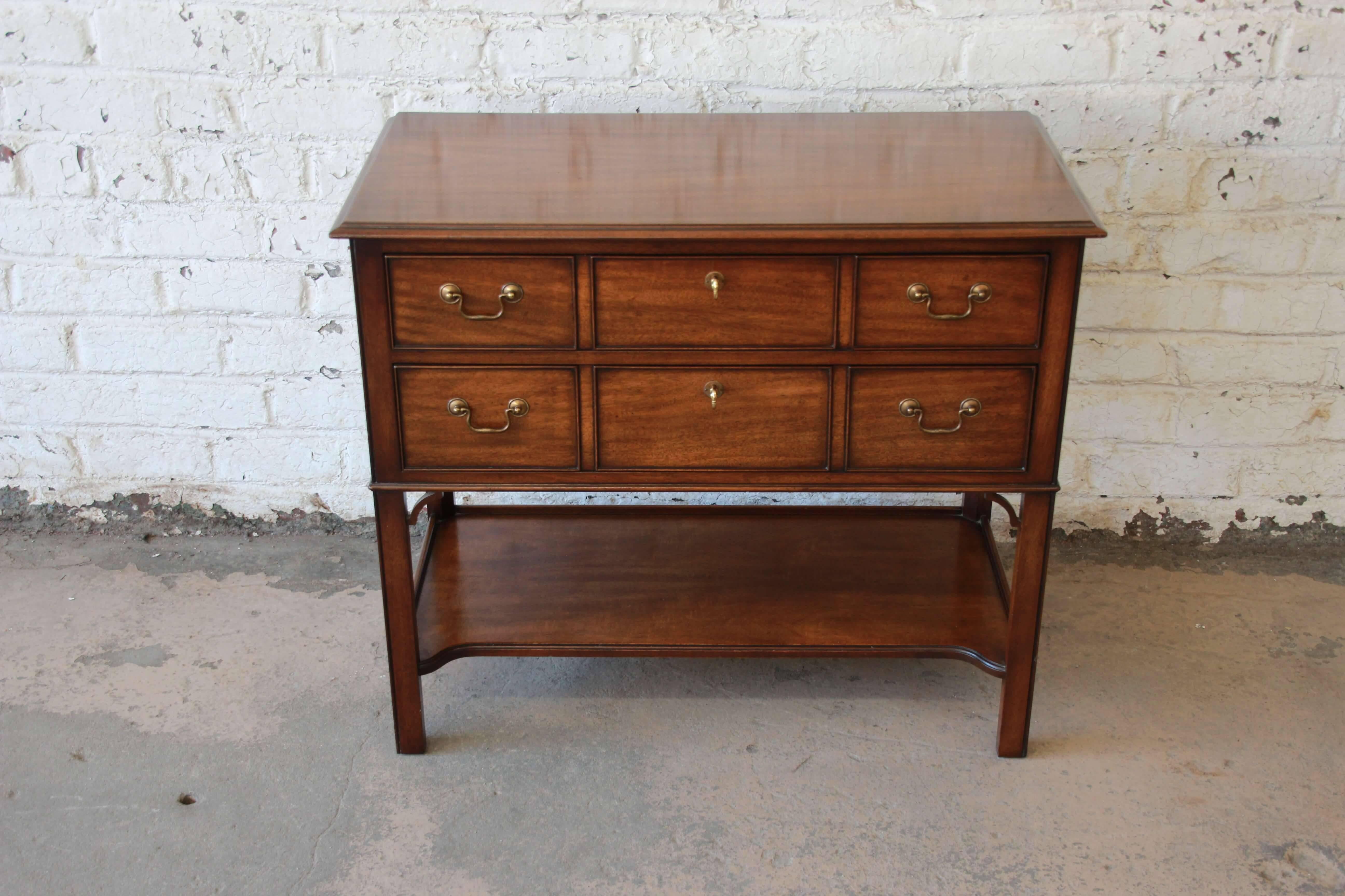 Offering a very nice Kindel Furniture sideboard server. The server has a moderate Asian style to it would brass details and two drawers for ample storage. The bottom of the server also has a shelf for storage and display. The server comes with two