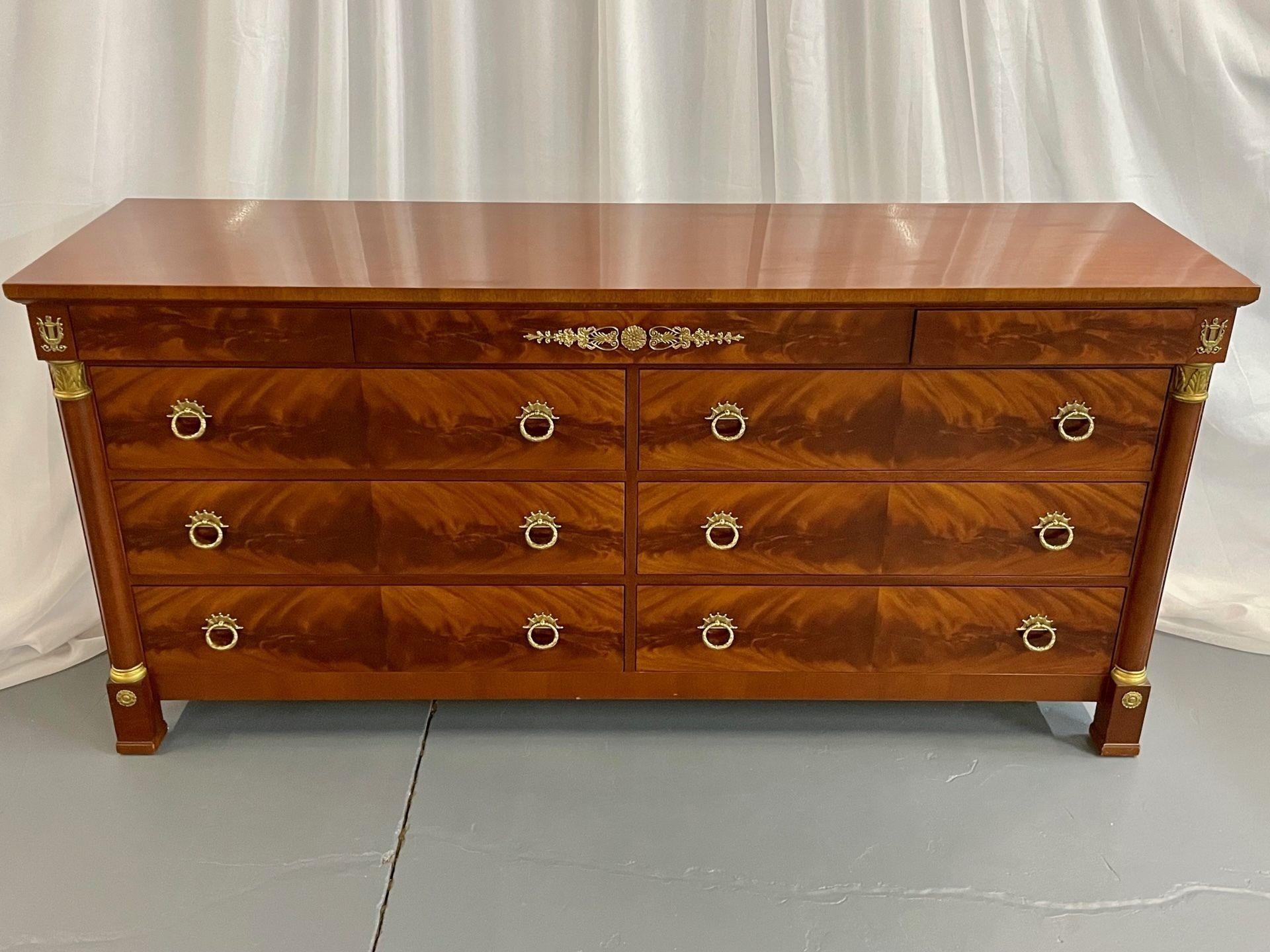 Kindel neoclassical Collection gilt brass mounted flame Mahogany double dresser
 
Flame mahogany dresser, sideboard having three smaller drawers on top of a double commode of three by three drawers all in a flame mahogany finish with bronze pulls