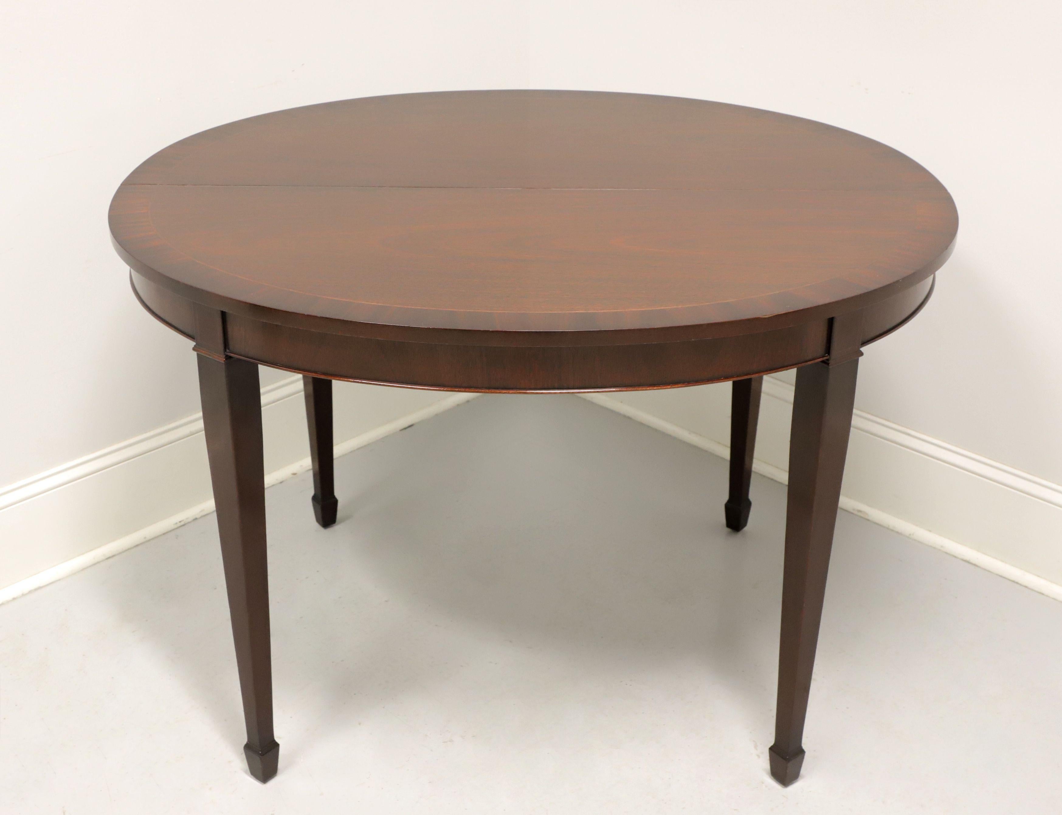 A Federal style oval dining table by Kindel Furniture, of Grand Rapids, Michigan, USA. Mahogany with banded top, their 