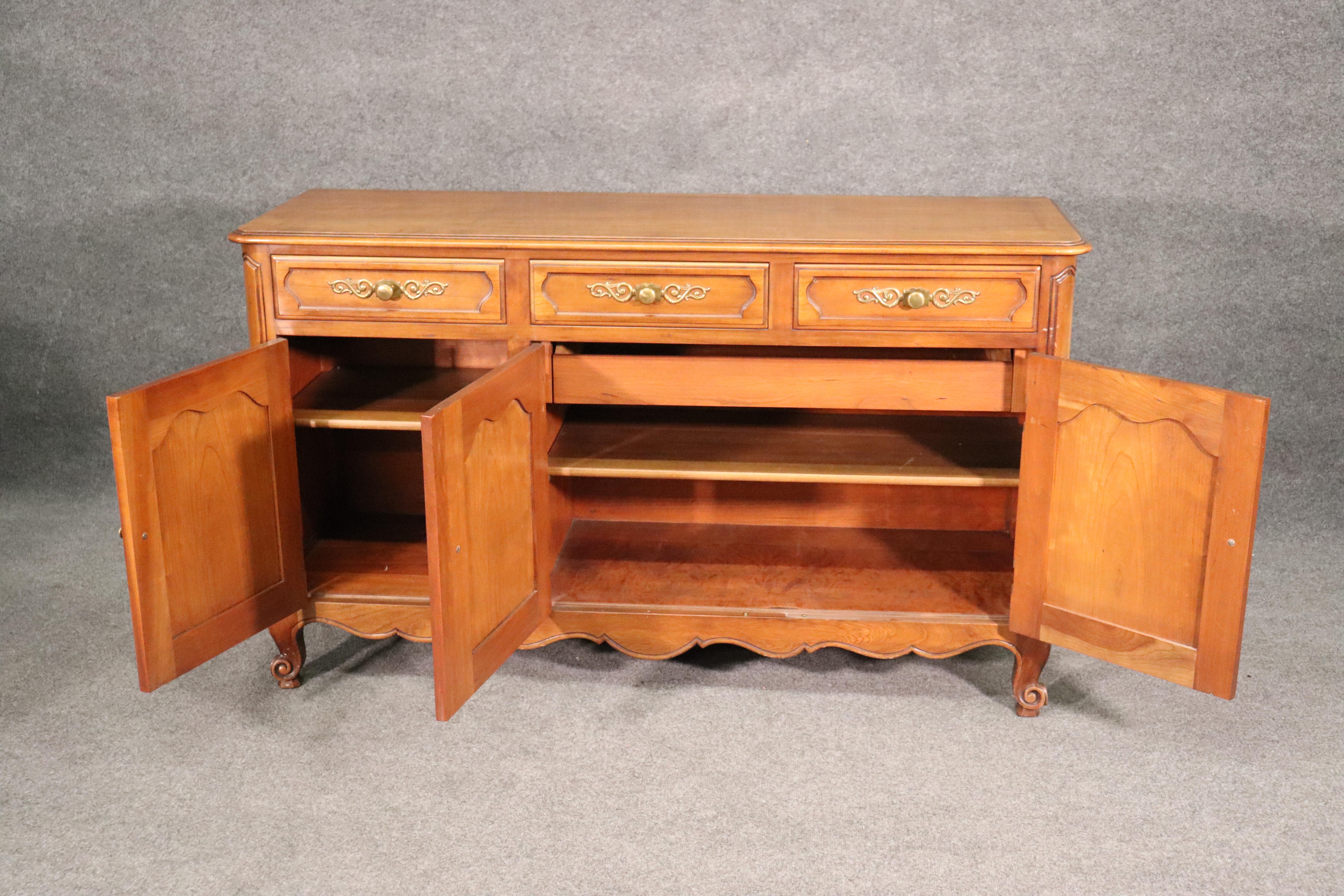 This is a beautiful solid cherry Kindel sideboard designed in the French Louis XV style. The piece measures 57 wide x 34 tall x 19 inches deep and is shallow so it can fit anywhere,.