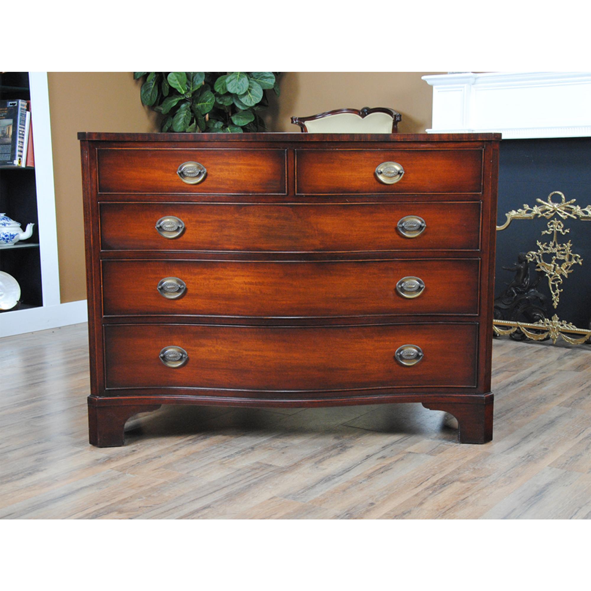 A Kindel Vintage Mahogany Dresser of exceptional scale and quality. A traditionally crafted seprentine front dresser in excellent condition, having recently been restored. From the well developed and canted bracket feet moving up through the