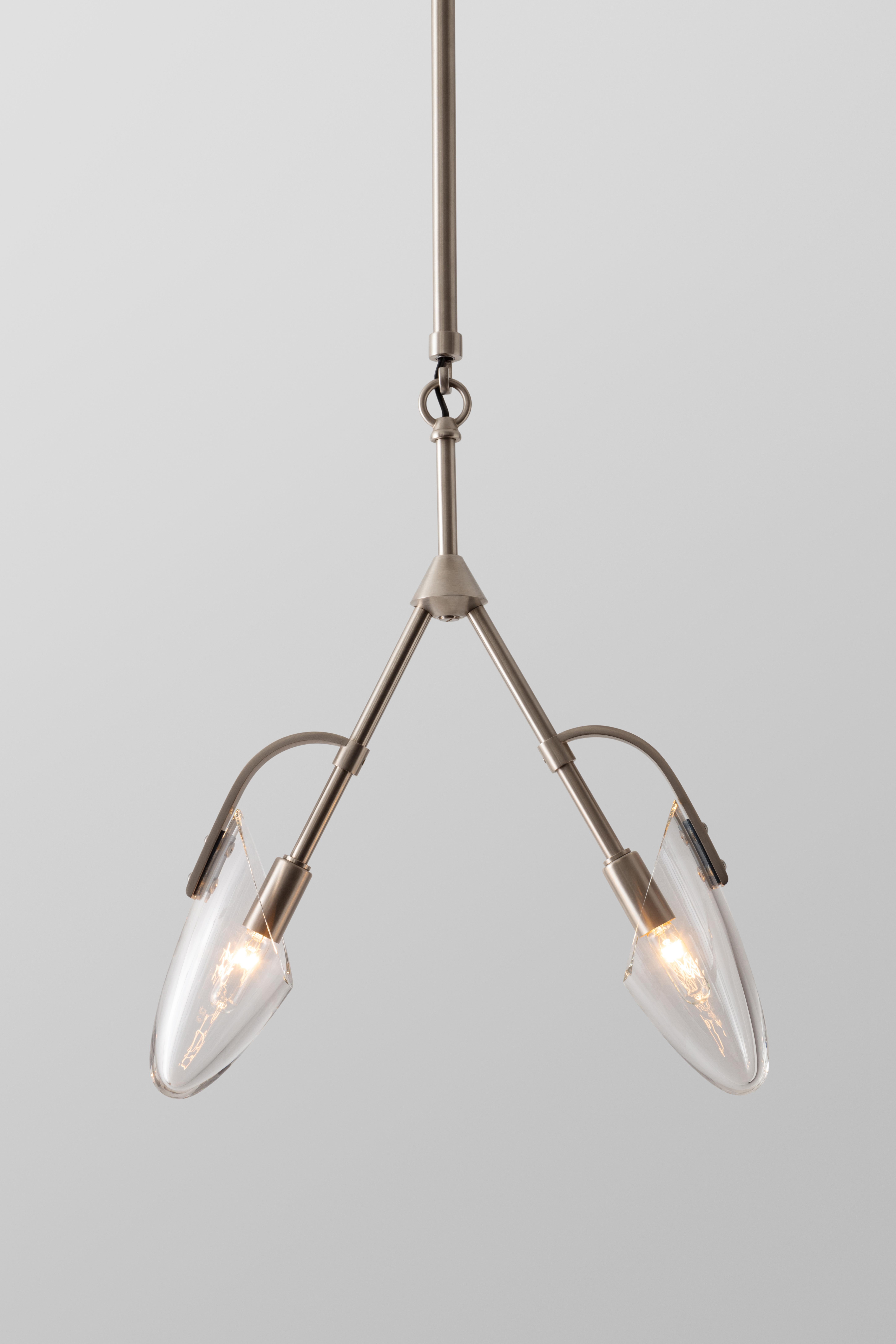 The Kinesis Pendant is part of a modular lighting system. This pendant has two mouth-blown glass diffusers and is available in a variety of metal finishes. The details of Kinesis owe their beauty to a merging of traditional hand craftsmanship and