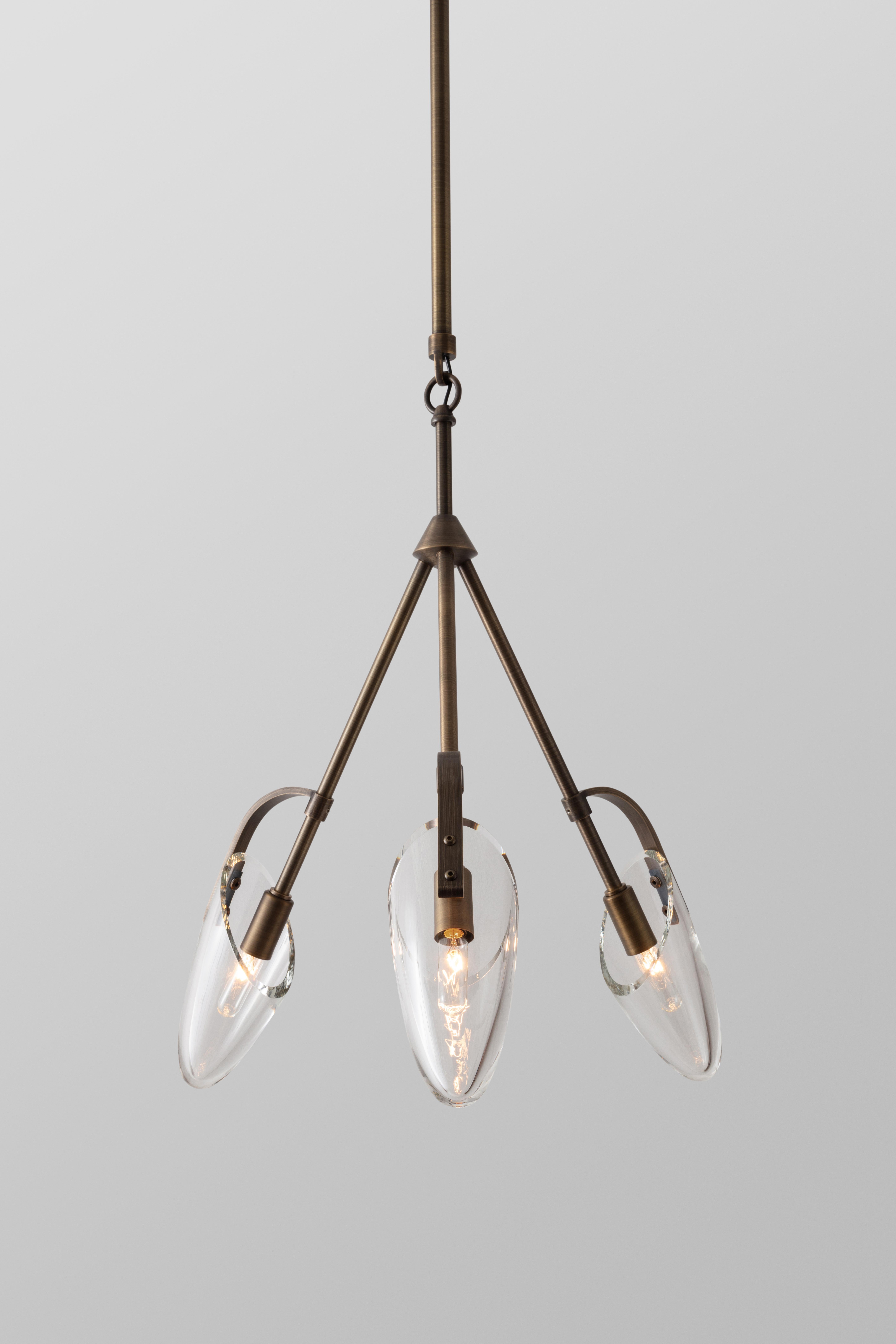 The Kinesis Pendant is part of a modular lighting system. This pendant has three mouth-blown glass diffusers and is available in a variety of metal finishes. The details of Kinesis, owe their beauty to a merging of traditional hand craftsmanship and