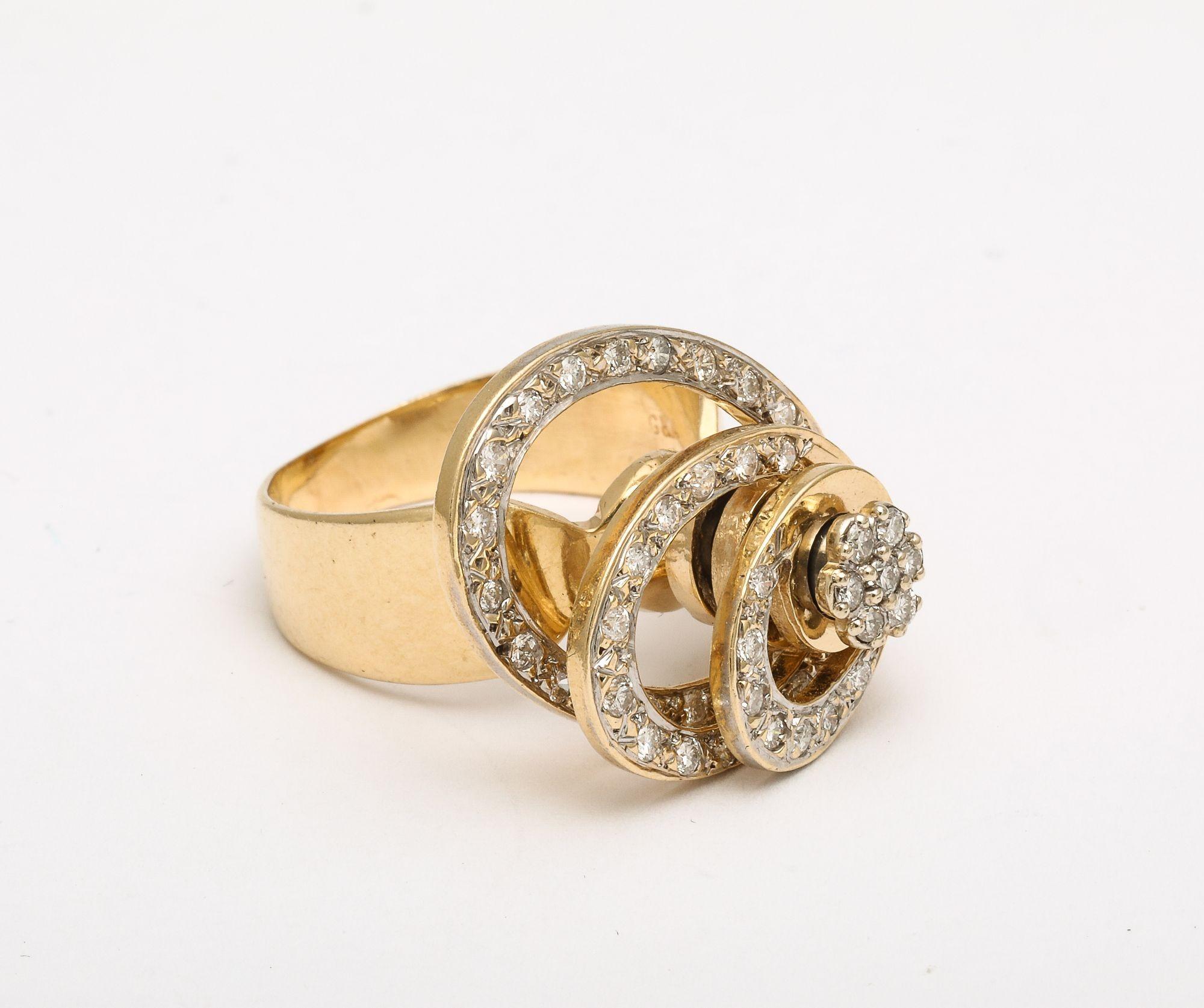 A wonderful Kinetic Diamond and 14 k Gold Spinner Ring. Concentric circles of set diamonds revolve around a central pillar giving movement to a well designed interesting ring.