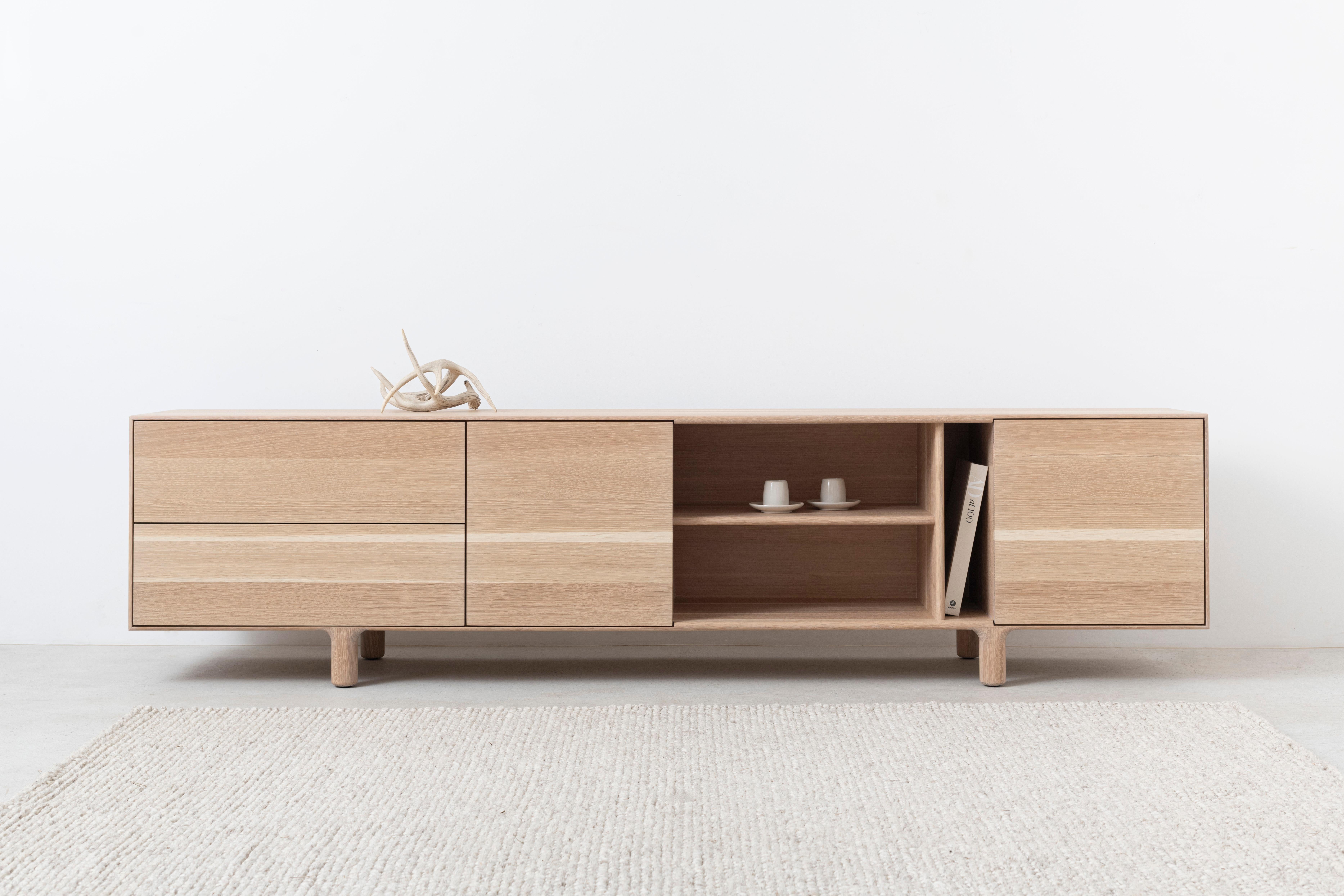 This cabinet is ready to ship & nearly 25% off! Only one available!
Kinetic by Izm is a solid hardwood sideboard featuring an asymmetric arrangement of drawers, doors, and open shelving w flush mounted, continuous grain faces. This modern cabinet