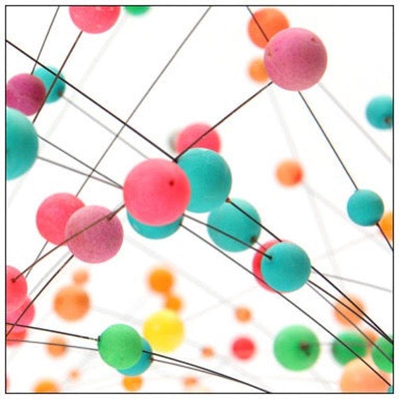 A kinetic sculpture comprised of variegated balls on undulating wire rods stemming from a metal pedestal. A selection is available in varied colors.