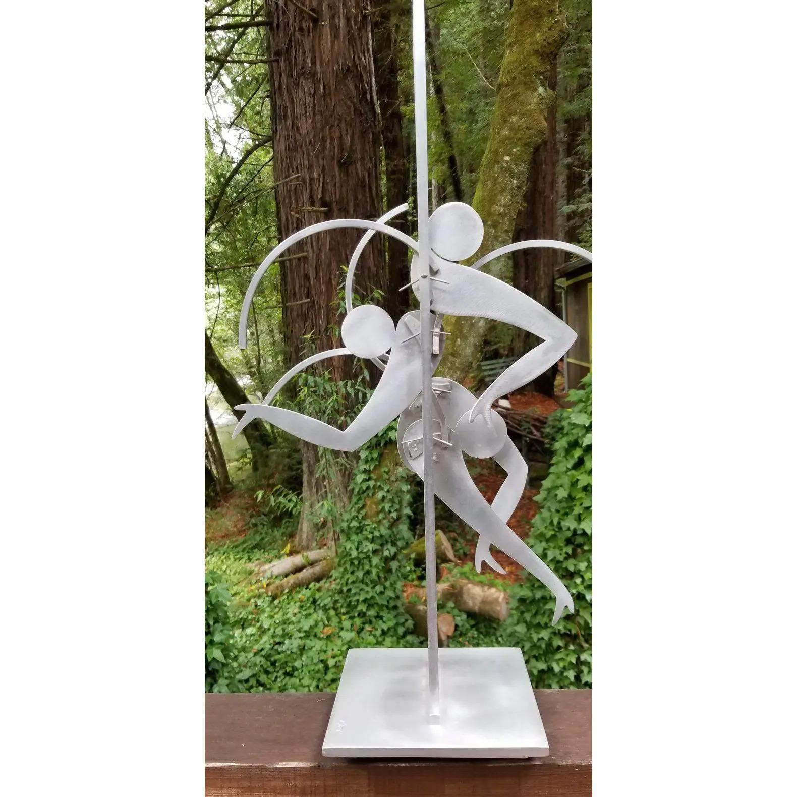 Exceptional abstract kinetic metal table top sculpture by Jerome Kirk. Dancing figures, signed and dated 1995. Sculpture base measures 8