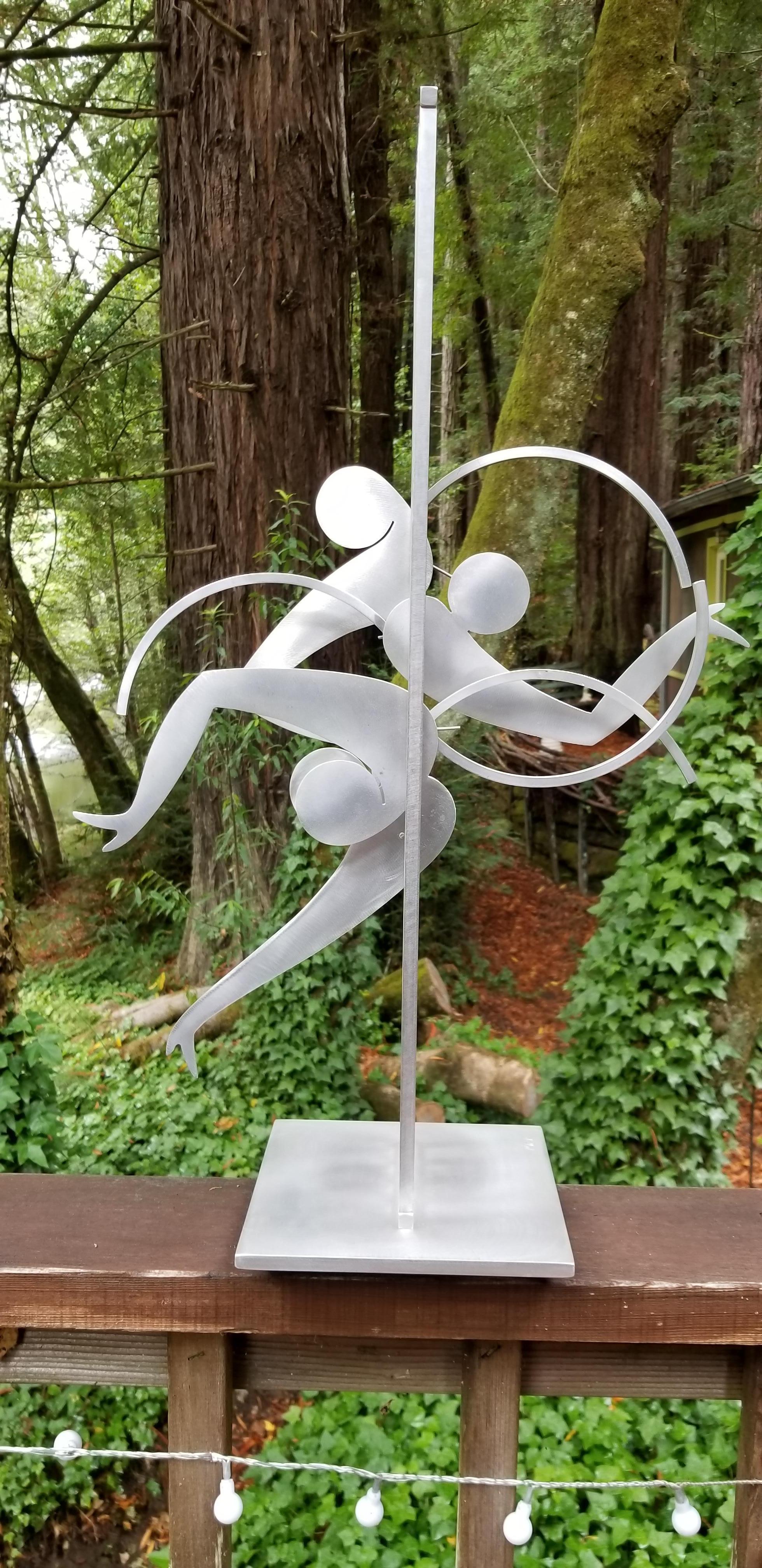 Exceptional abstract kinetic metal table top sculpture by Jerome Kirk. Dancing figures, signed and dated 1995. Sculpture base measures 8