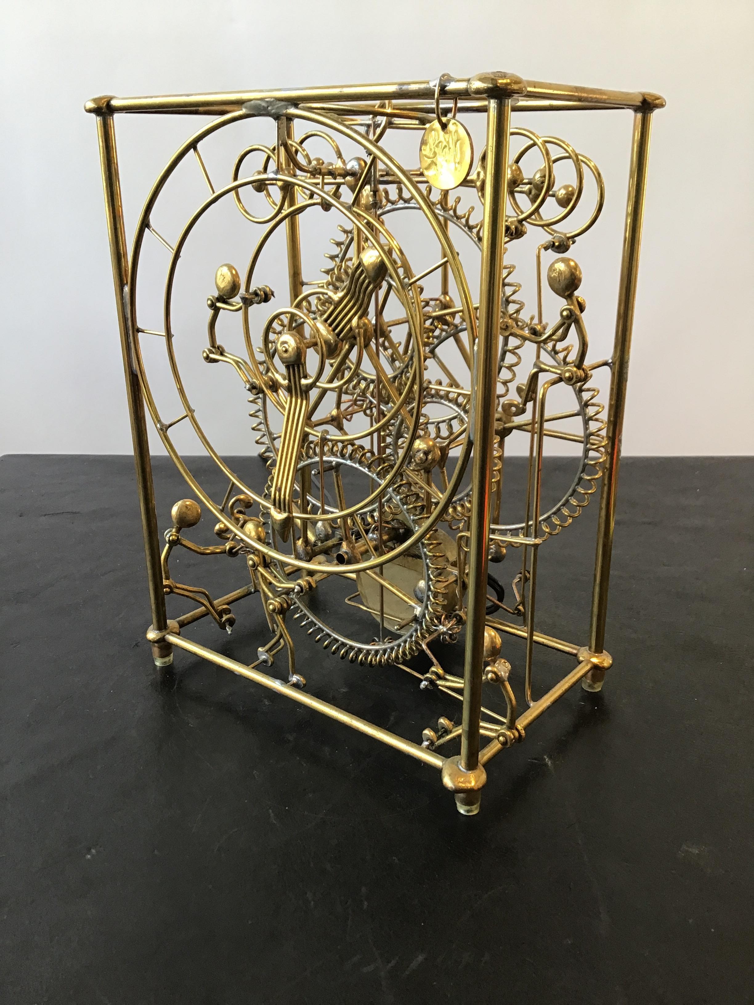 Six man kinetic solid brass clock by Gordon Bradt.