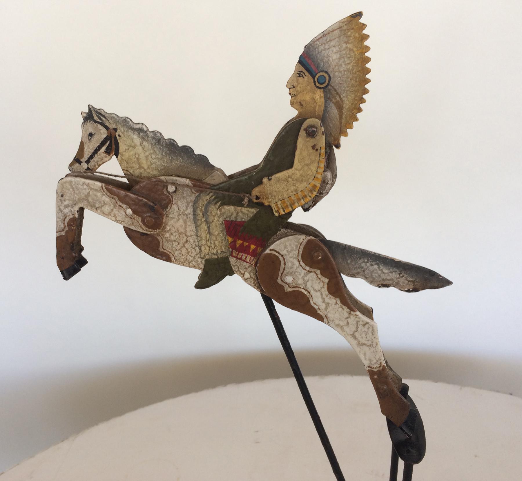 Painted metal kinetic sculpture of a Indian chief in full headdress riding a galloping horse. Poly chromed finish crackle finish. From the 1980s. Well made intricate heavy sculpture. Measures: 20 inches tall.