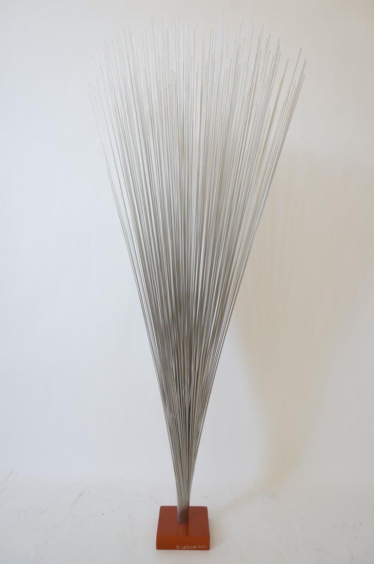 This stylish and chic stainless steel kinetic sculpture takes its form from the mid 20th century pieces by Harry Bertoia and is a modern interpritaion by D. Larson.

Note: Signed and dated on one side of the base.