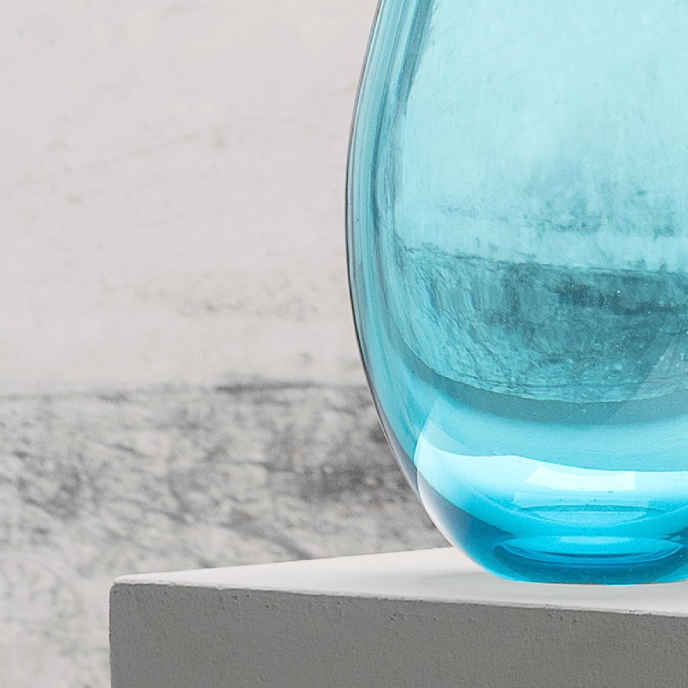A striking addition to a contemporary home, this vase is part of a collection of colorful and sophisticated vases designed by Karim Rashid in 2013. This piece was entirely crafted of mouth-blown Murano glass and its shape is elongated and elegant,