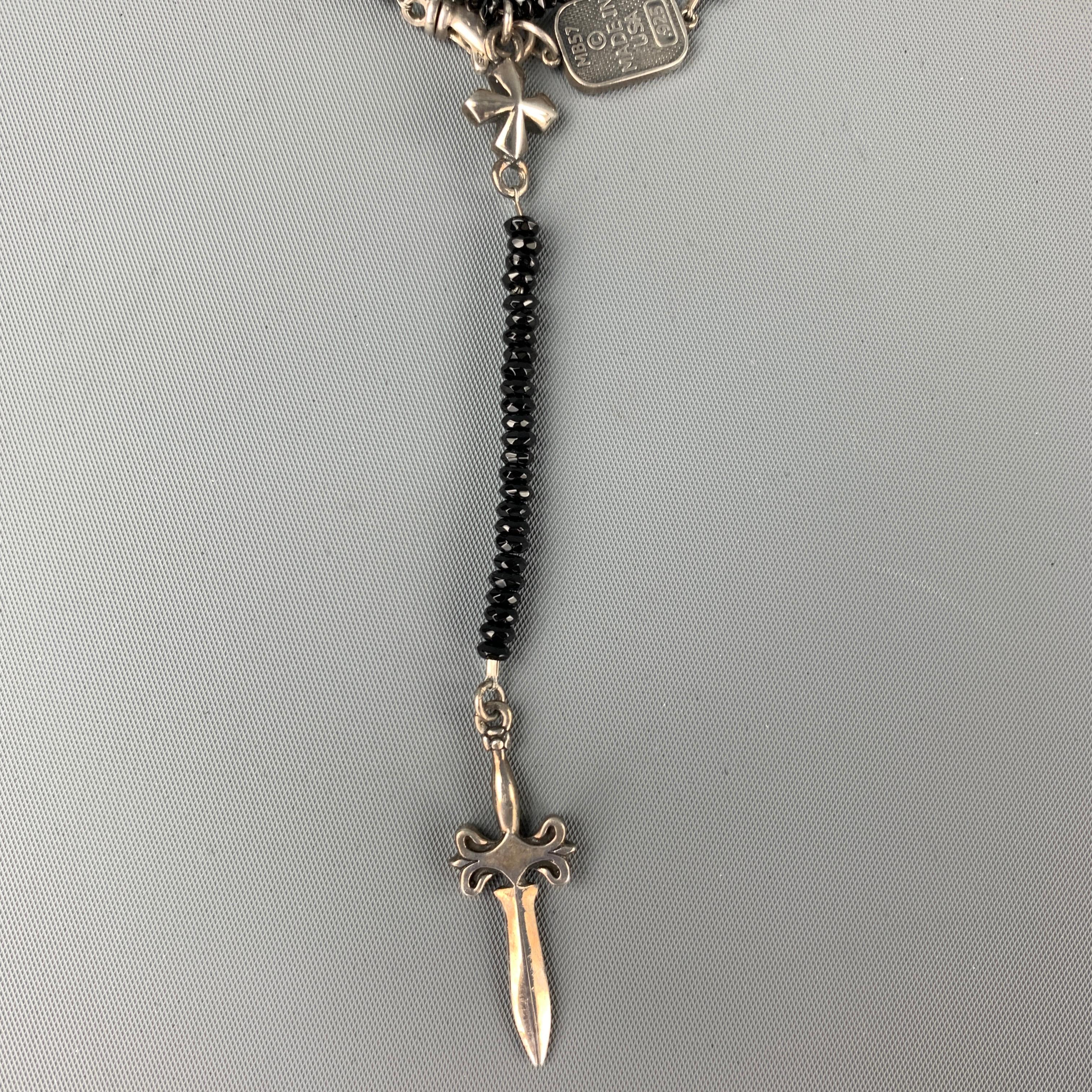 KING BABY necklace comes in a black beads featuring sterling silver dagger cross and a clasp closure.

Excellent Pre-Owned Condition.

Measurements:

Length: 29 in. 