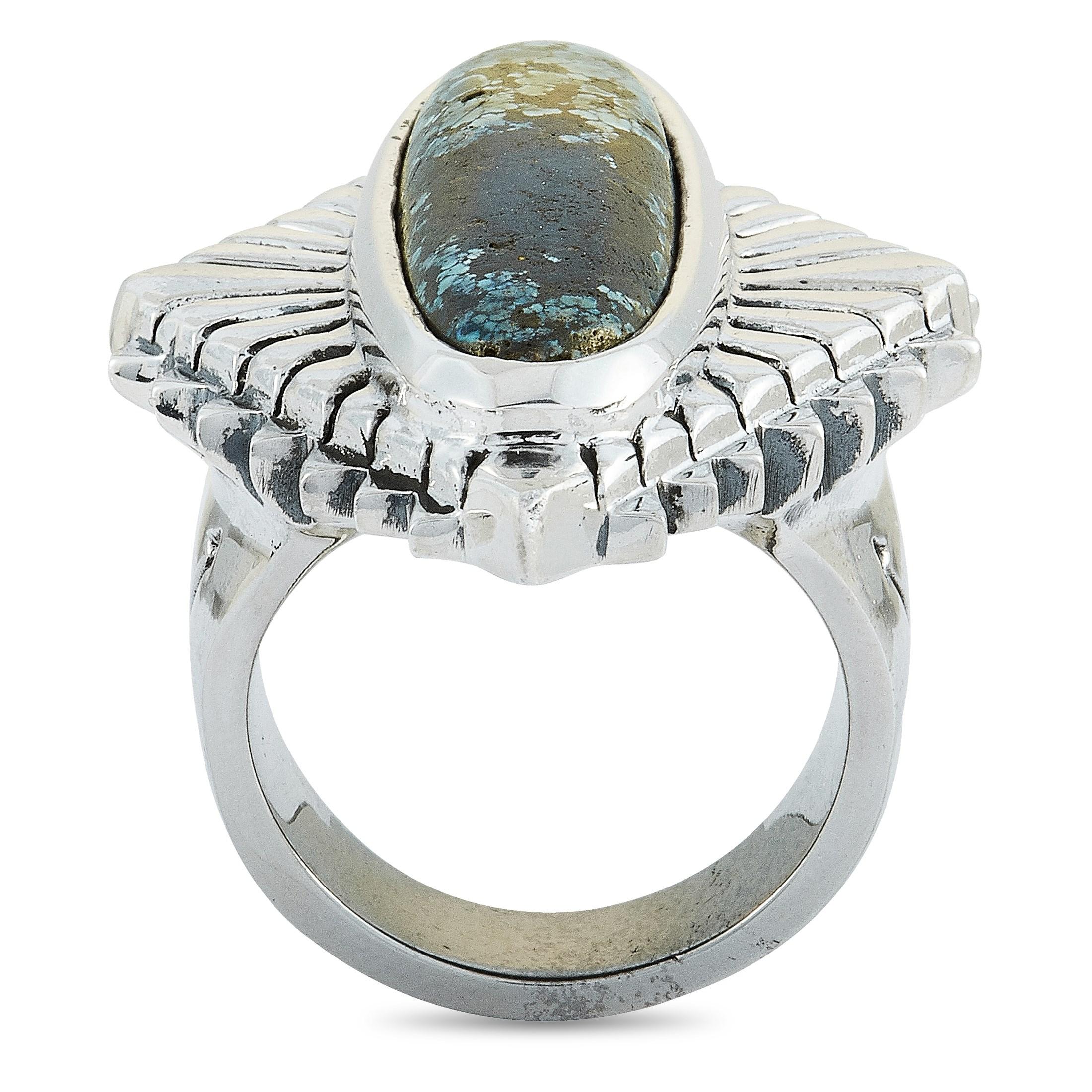 The King Baby “Concho” ring is crafted from silver and set with a spotted turquoise. The ring weighs 44.6 grams and boasts a band thickness of 7 mm and a top height of 9 mm, while top dimensions measure 30 by 41 mm.

This item is offered in