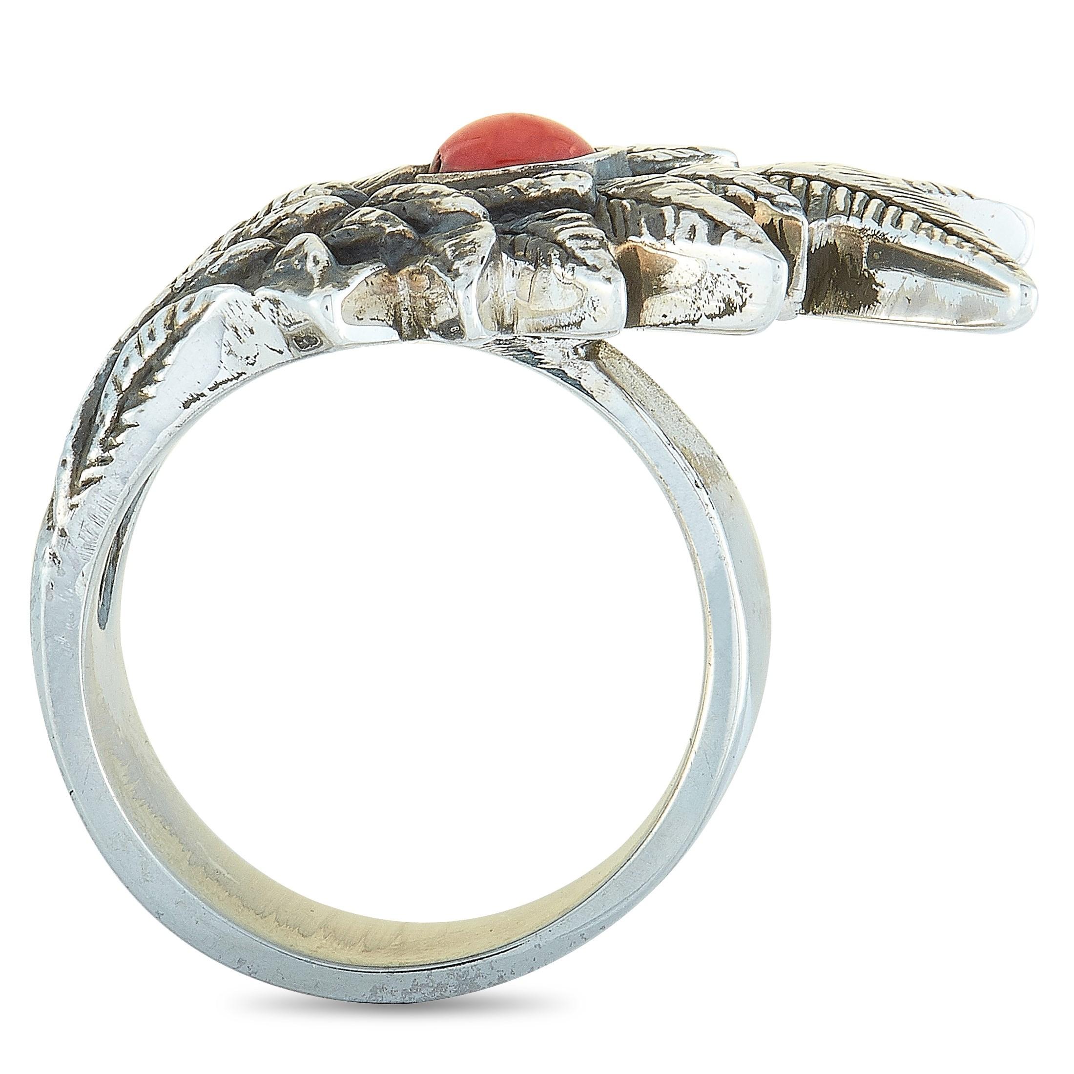 The King Baby “Raven Wing” ring is crafted from sterling silver and set with a coral cabochon. The ring weighs 28.1 grams and boasts a band thickness of 7 mm and top height of 7 mm, while top dimensions measure 32 by 21 mm.

This item is offered in