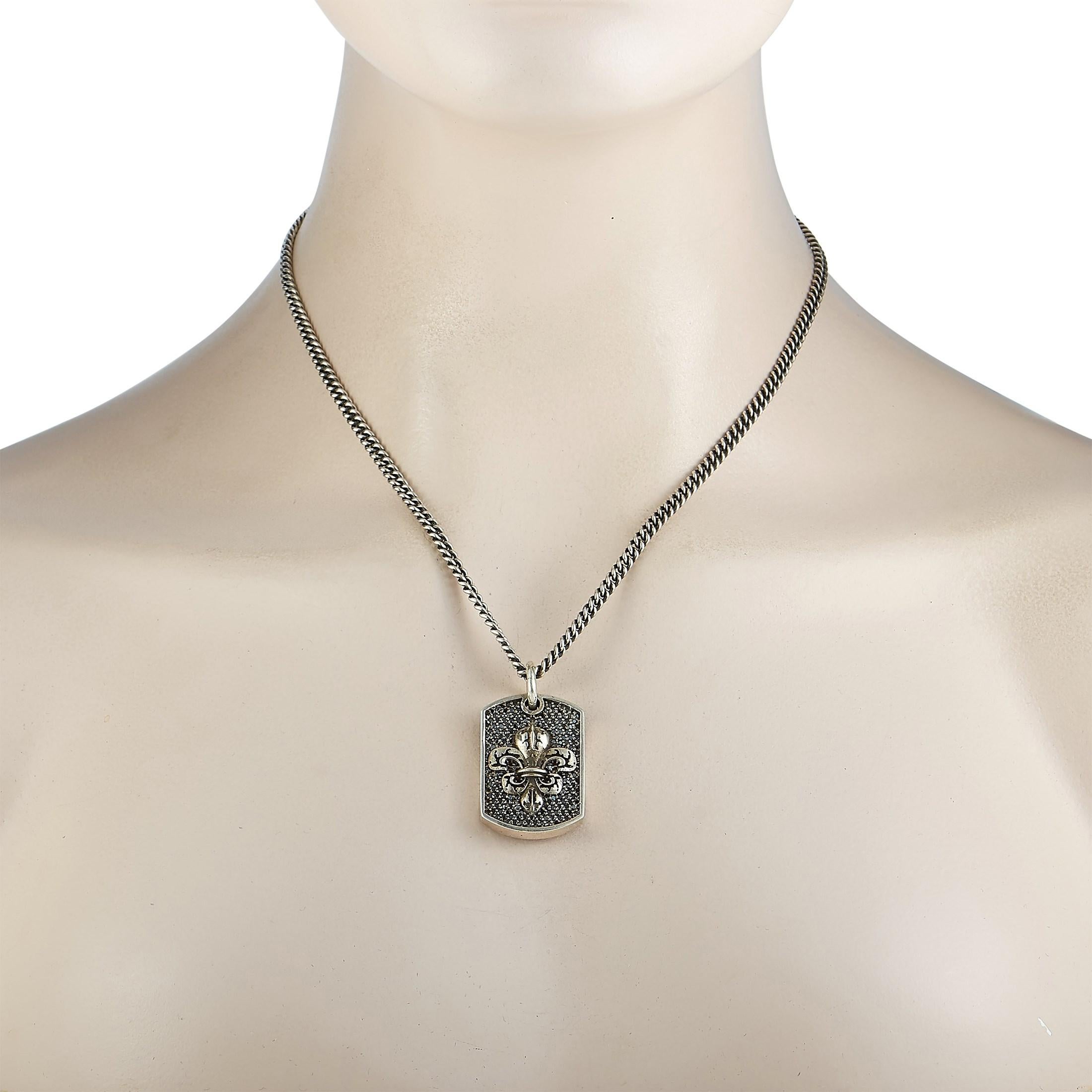This King Baby necklace is made of silver and embellished with black diamonds. The necklace weighs 38 grams and is presented with an 18” chain, boasting a 1.62” by 0.87” dog tag pendant with a fleur-de-lis motif.

Offered in brand-new condition,