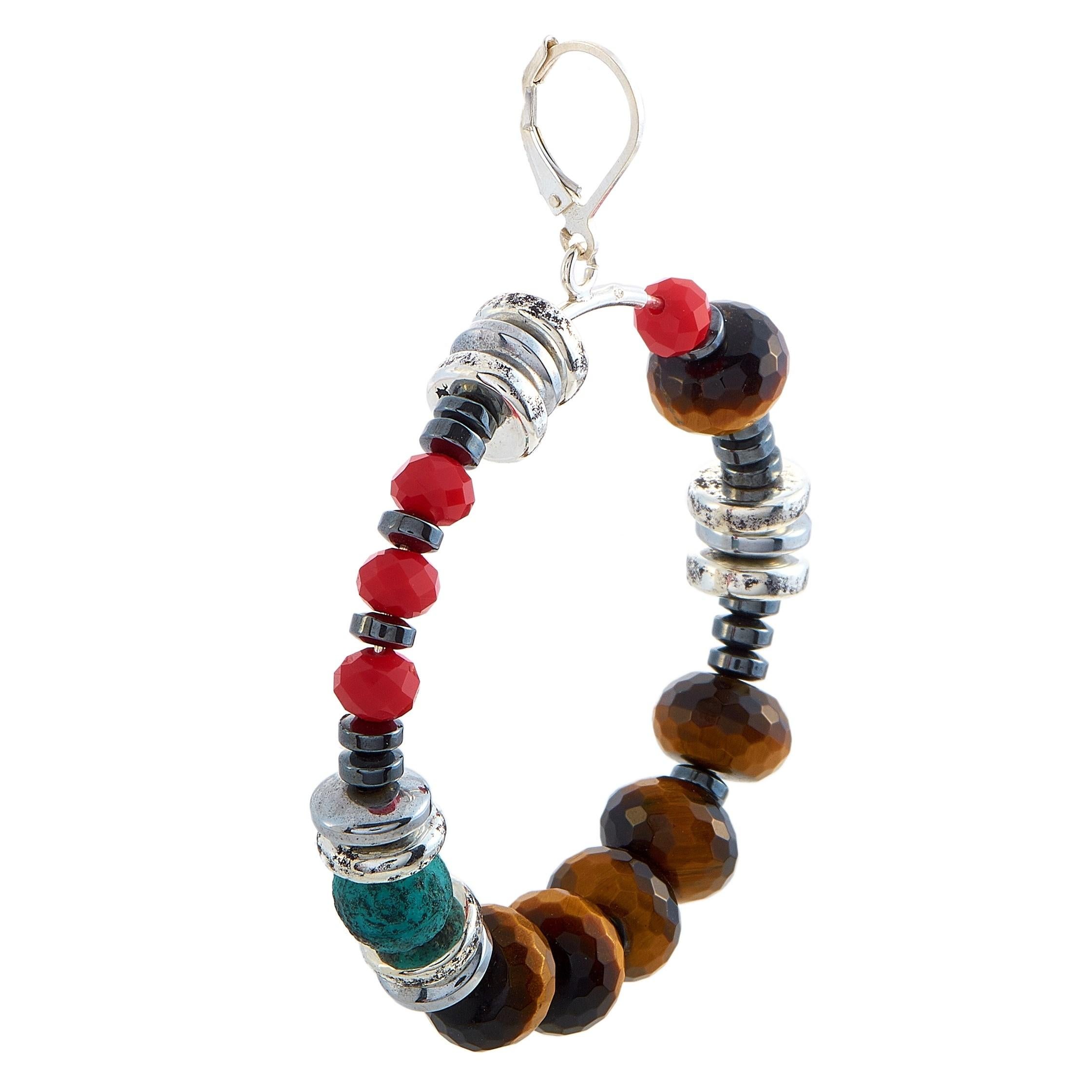 These King Baby earrings are made of silver and embellished with ceramic, hematite, and Czech glass beads. The earrings measure 2.50” in length and 0.37” in width and each of the two weighs 15 grams.

The pair is offered in brand-new condition and