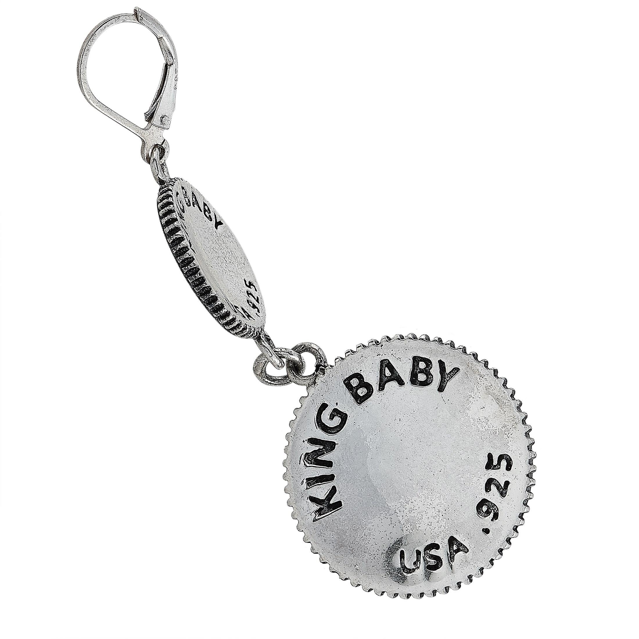 These King Baby earrings are made of silver and each of the two weighs 14.1 grams, measuring 2.62” in length and 0.90” in width.

The pair is offered in brand-new condition and includes the manufacturer’s box.