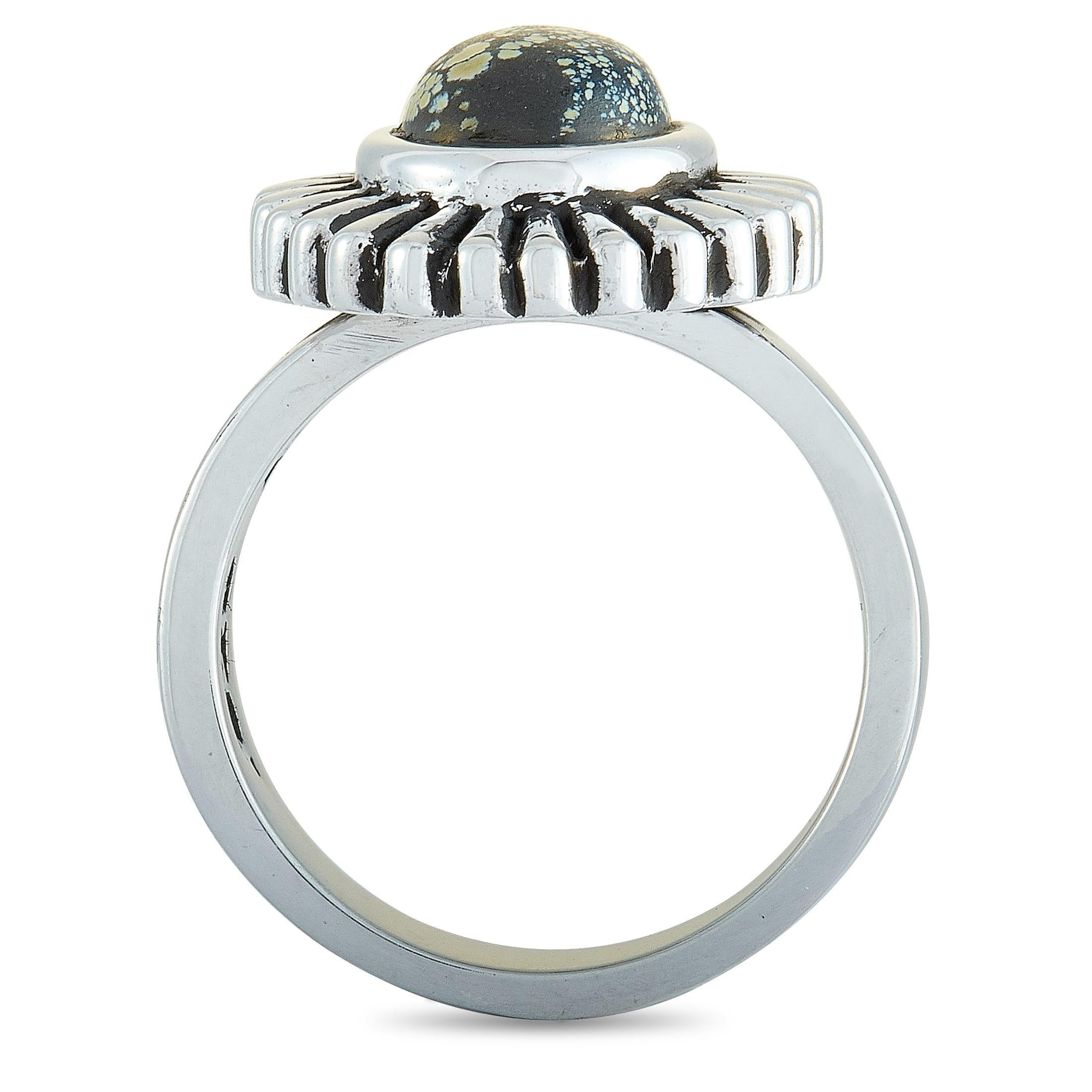 The King Baby “Small Starburst Concho” ring is crafted from silver and set with an 8 by 10 mm spotted turquoise. The ring weighs 15 grams and boasts a band thickness of 5 mm and a top height of 8 mm, while top dimensions measure 17 by 21 mm.

This