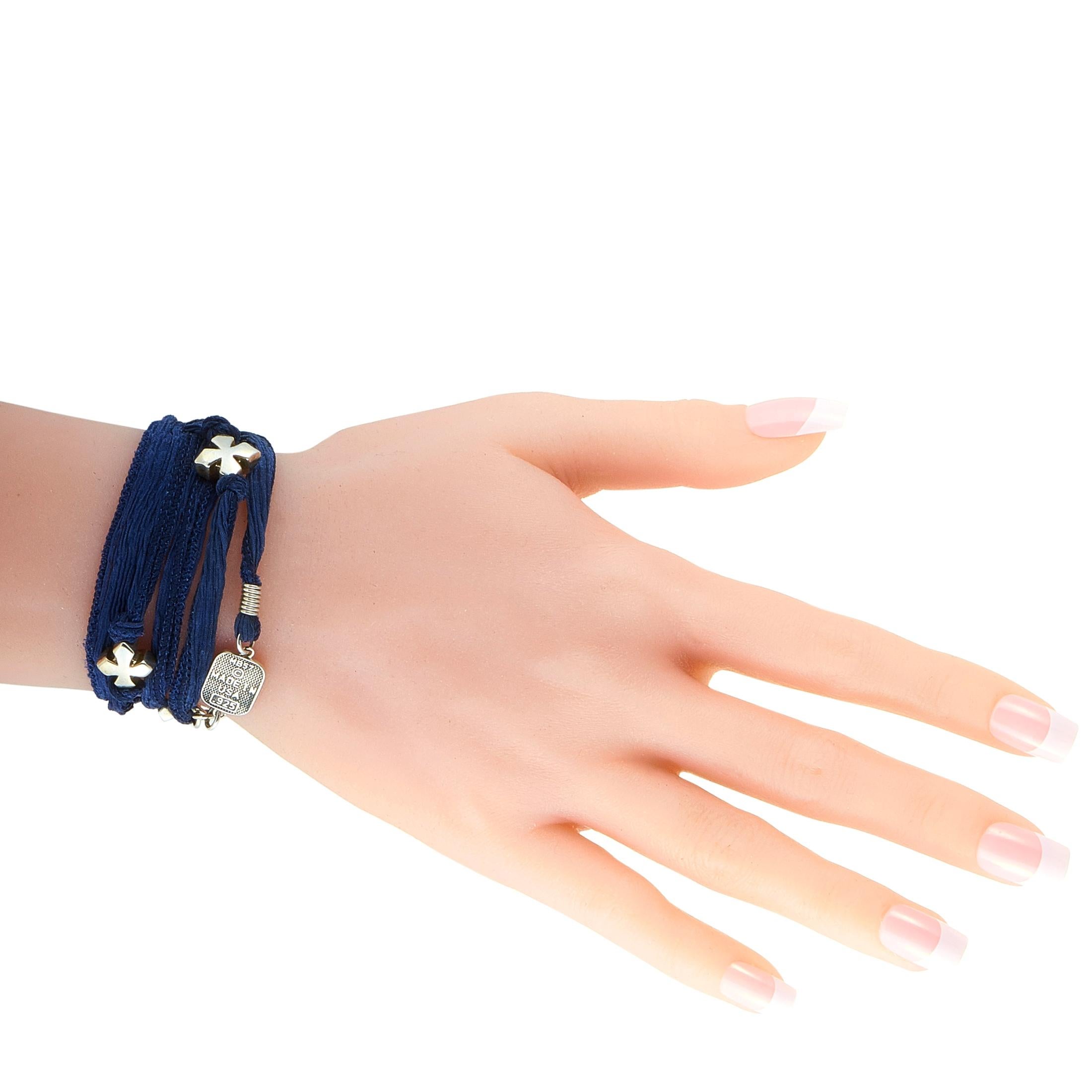 This King Baby bracelet is presented with a 28” indigo silk cord that boasts inserts in sterling silver. The bracelet weighs 17.9 grams.

Offered in brand new condition, this jewelry piece includes the manufacturer’s pouch.