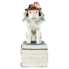 Antique King Charles Cavalier porcelain box, sitting on the books, England 1850.