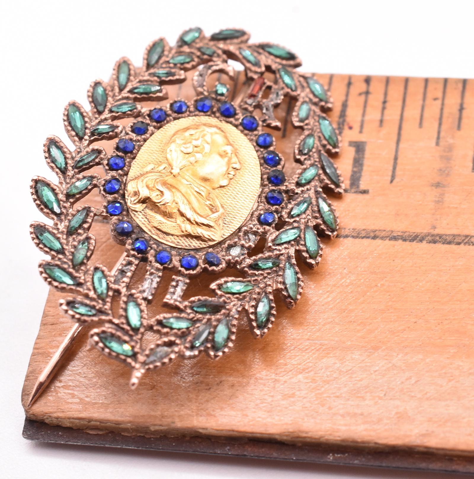 Rarely seen George III commemorative brooch with George III in profile at the center and decorated with a border of blue and green Vauxhall glass. This historical brooch was thought to have been made to celebrate George III's recovery from porphyria