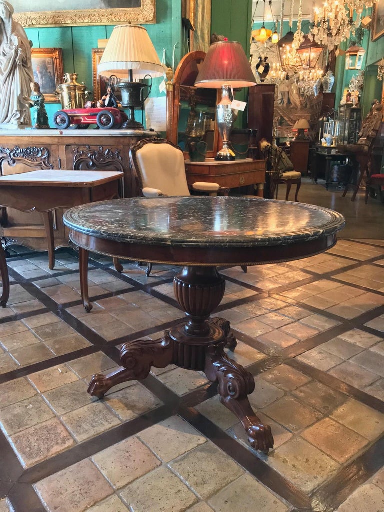Elegant French Louis Philippe marble-top center table mid-19th century. A fantastic marble top mahogany center Hall table. Superb quality shown in the bulbous and reed carved column, the gadrooned urn-form pedestal, on acanthus carved tripod legs