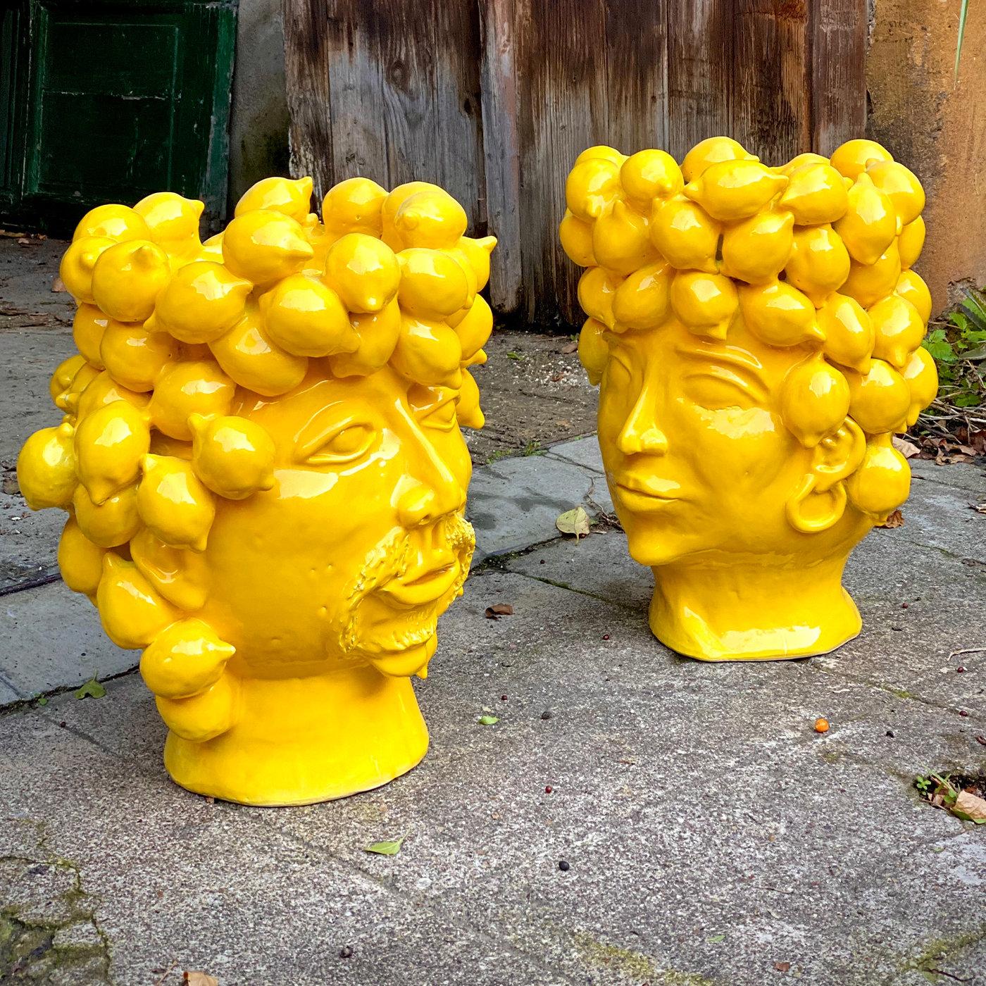 An explosion of solid yellow glaze envelopes the minutely detailed silhouette of this glamorous ceramic head, stunning piece to host flowers, plants, or to simply make an impactful statement on its own in living rooms or gardens, alike. Playfully
