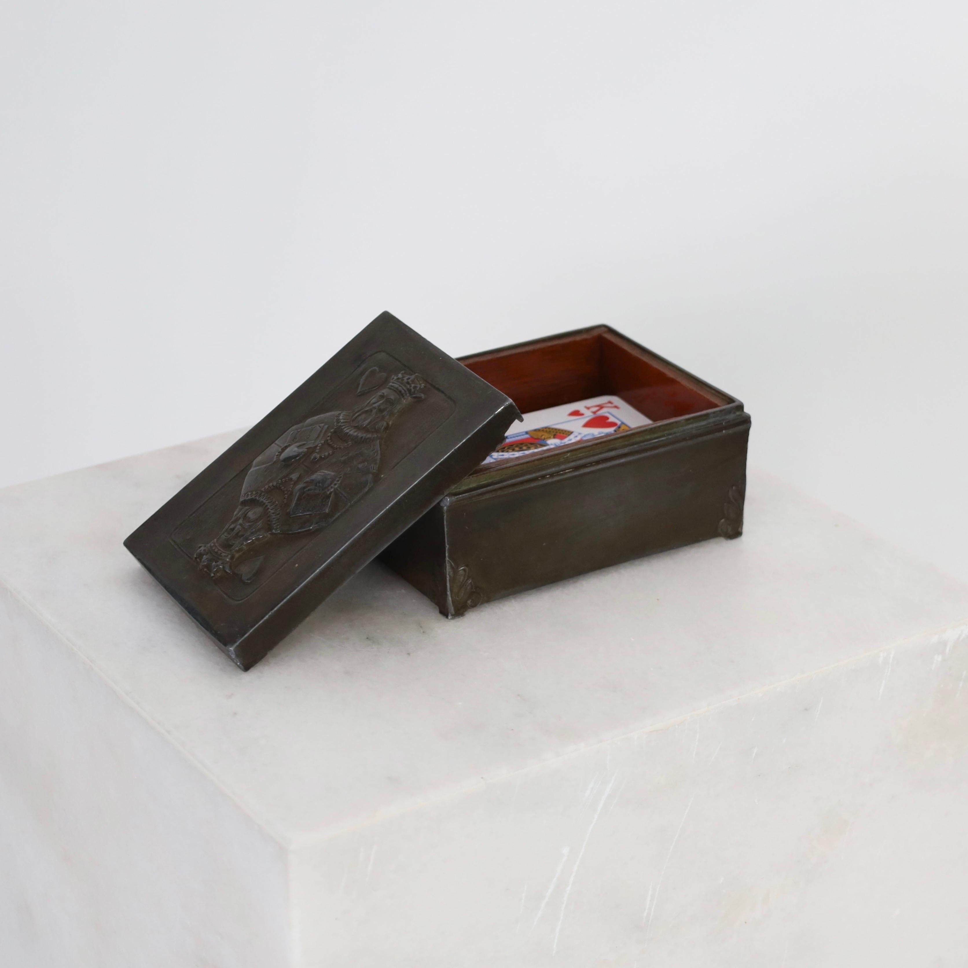 Lidded Casket for Playing Cards designed by Just Andersen in the early 1920s. A fine piece for a beautiful place. 

* A lidded casket in discometal with King of Hearts on the lid and a wood box inside.
* Designer: Just Andersen
* Model: D14 (stamped