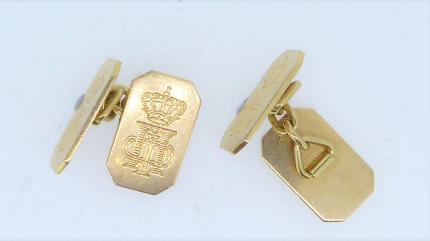 A pair of 18 Carat Yellow Gold Presentation Panel Cufflinks with the Royal Crown and Cipher of King Paul of Greece (1901- 1964). The cut cornered, rectangular double panel cufflink, connected by gold links each engraved with the royal crown above