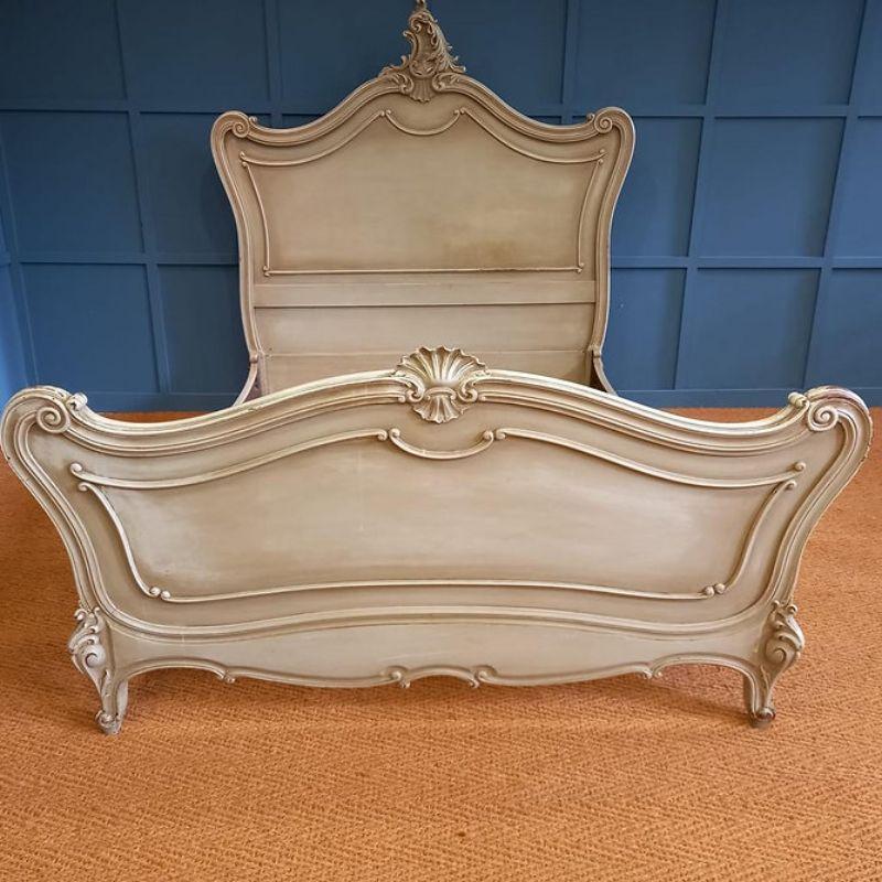 Stunning king size Louis XV in old paint which is worn in places. 

This is a lovely bed with beautiful carvings and can take a standard king size 5' wide by 6'6 long mattress.

Excellent patina. Complete with a superior firm bed base.

Measures: