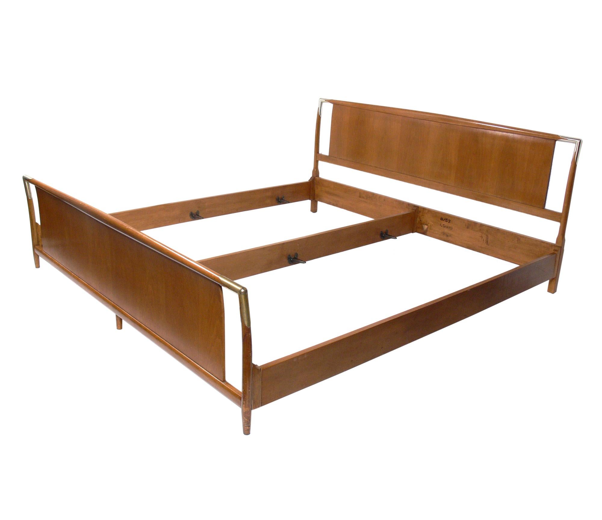 King size bed, designed by T.H. Robsjohn-Gibbings for Widdicomb, American, circa 1950s. This piece retains its original finish with warm original patina. If you would prefer it refinished, we can refinish in your choice of color and polish the