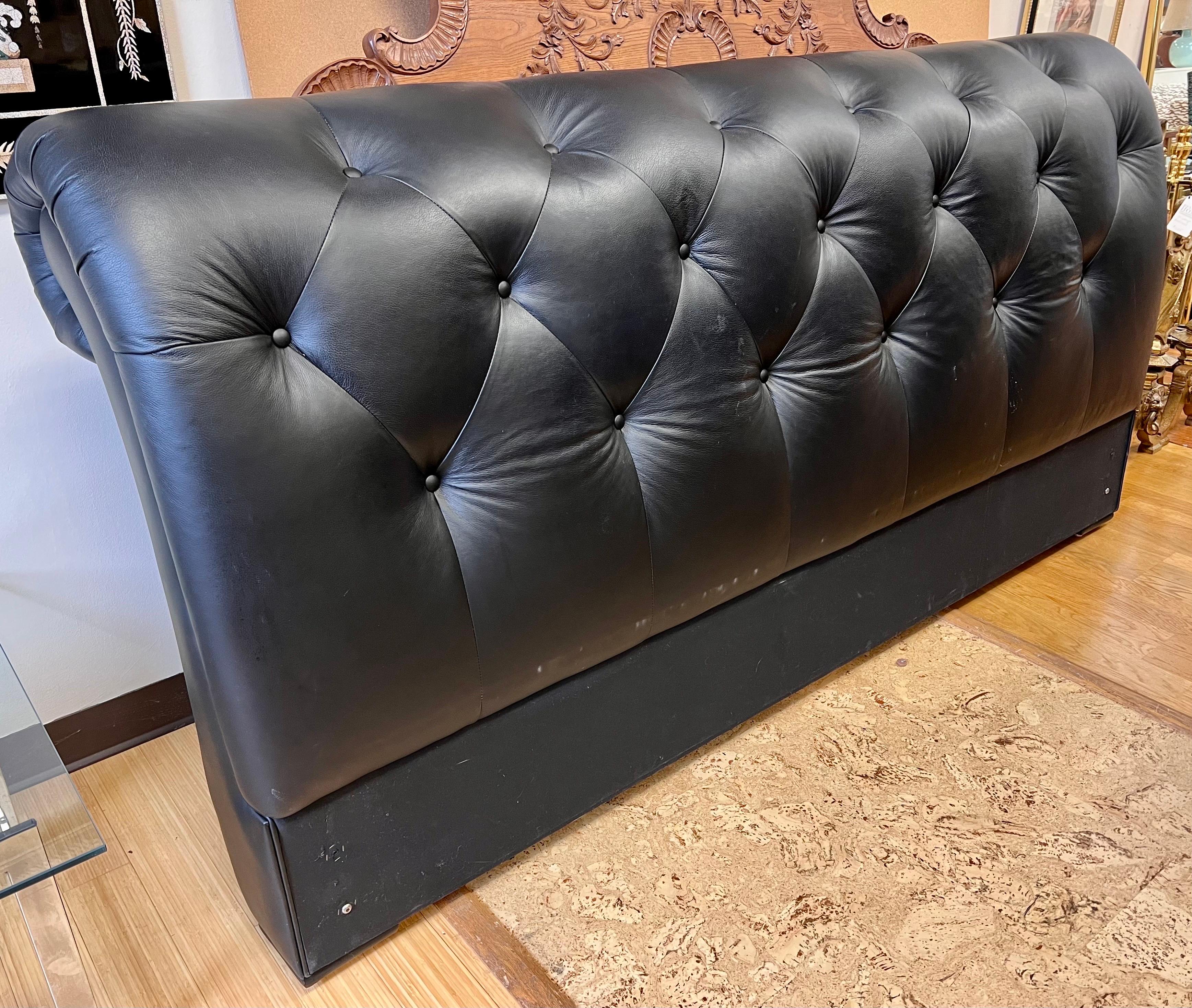 A handsome king-size tufted black leather headboard. Note there is no footboard or bed frame - just the headboard as shown. Has holes to screw in bed frame. Originally purchased at Lillian August.