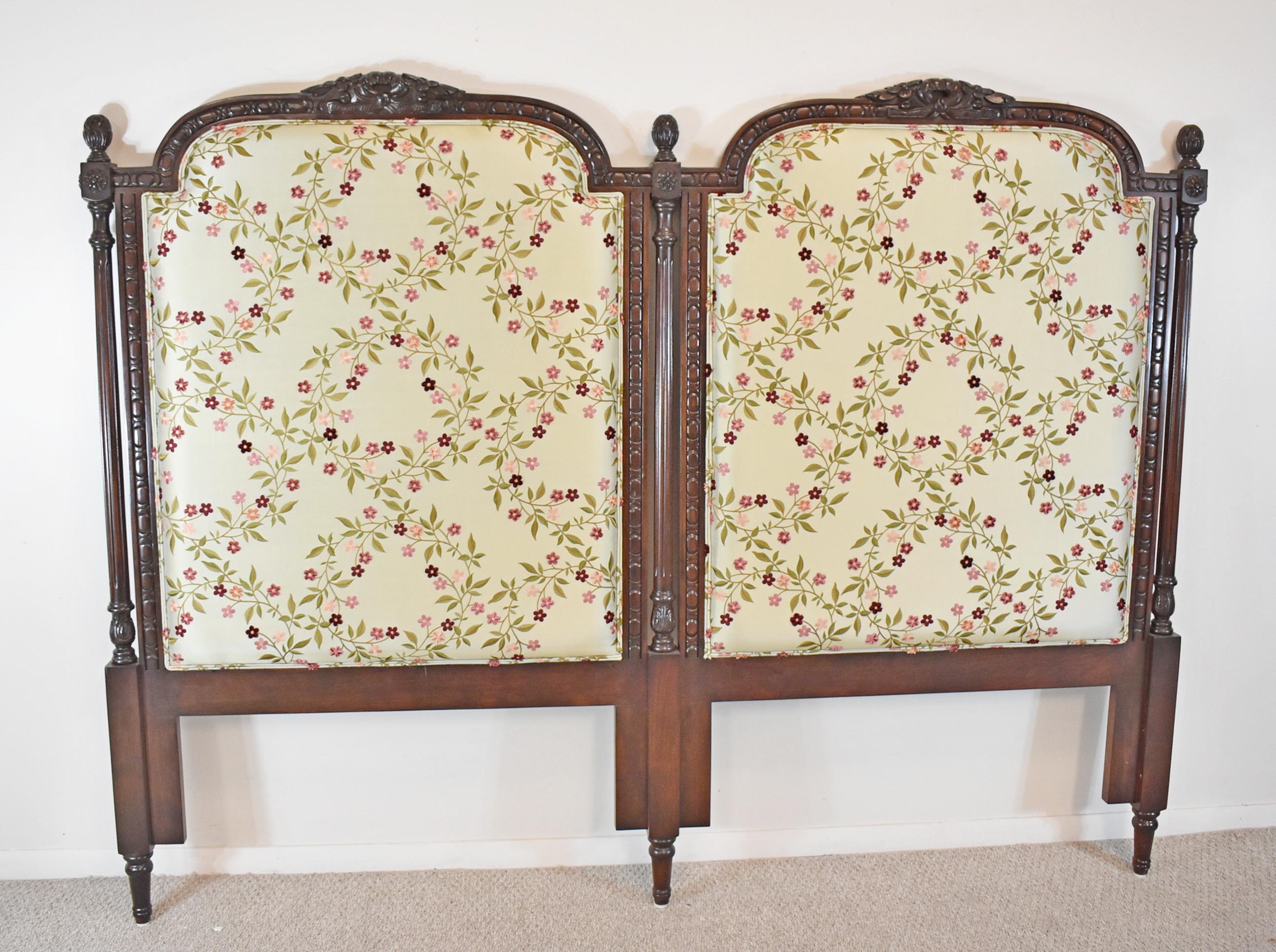 King Size Carved Mahogany Headboard. circa 19th century. Louis XVI Style. Mahogany carved frame with fluted pillars and pineapple finials. Embroidered ivory silk fabric with flowers. Excellent condition with some wear due to usage and age.