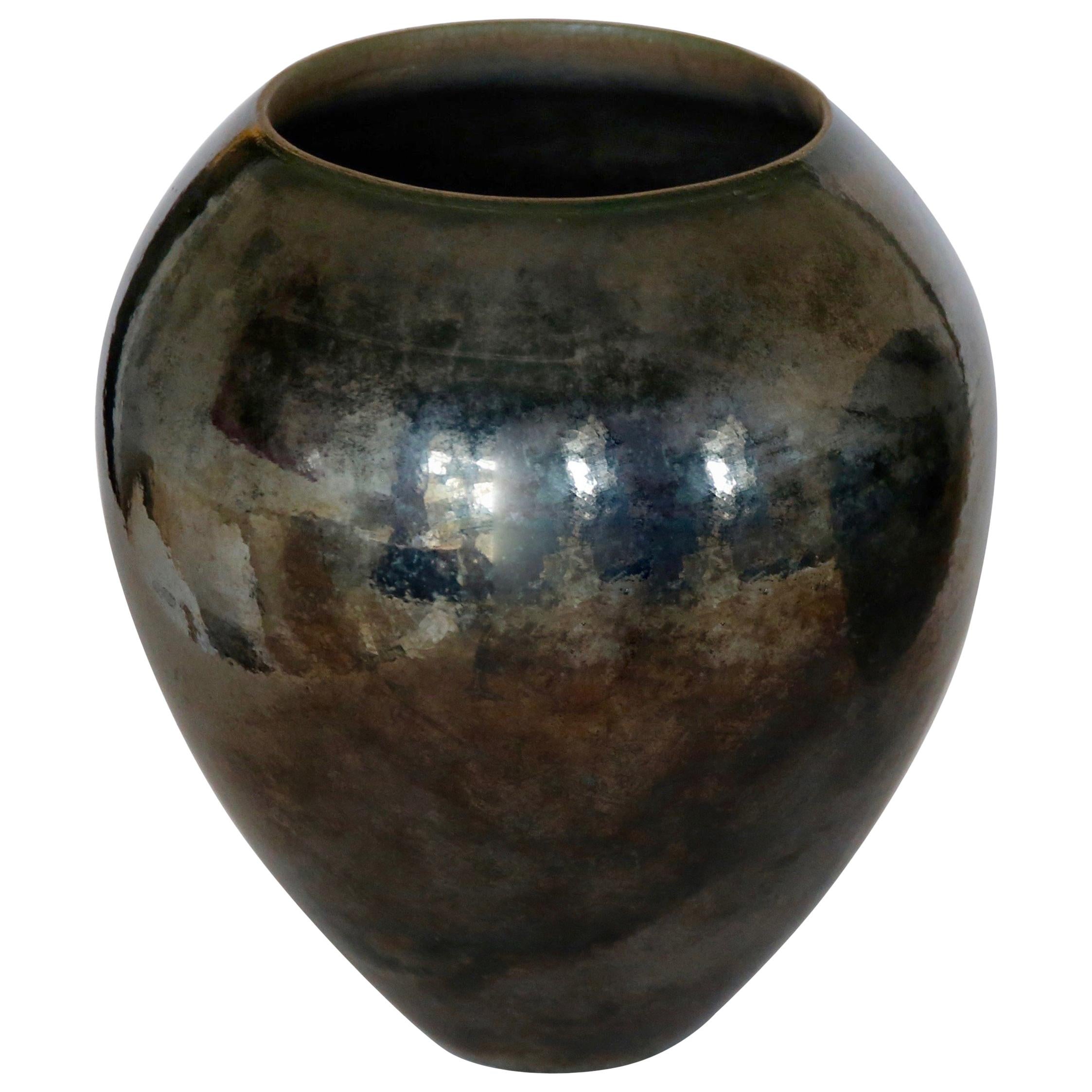 Unique big ceramic vase with black metallic pigment.
Many dark colors in the pigments oscillating from dark green, gold, silver, bronze, grays.
Changing aspect with the light. Beautiful.
 