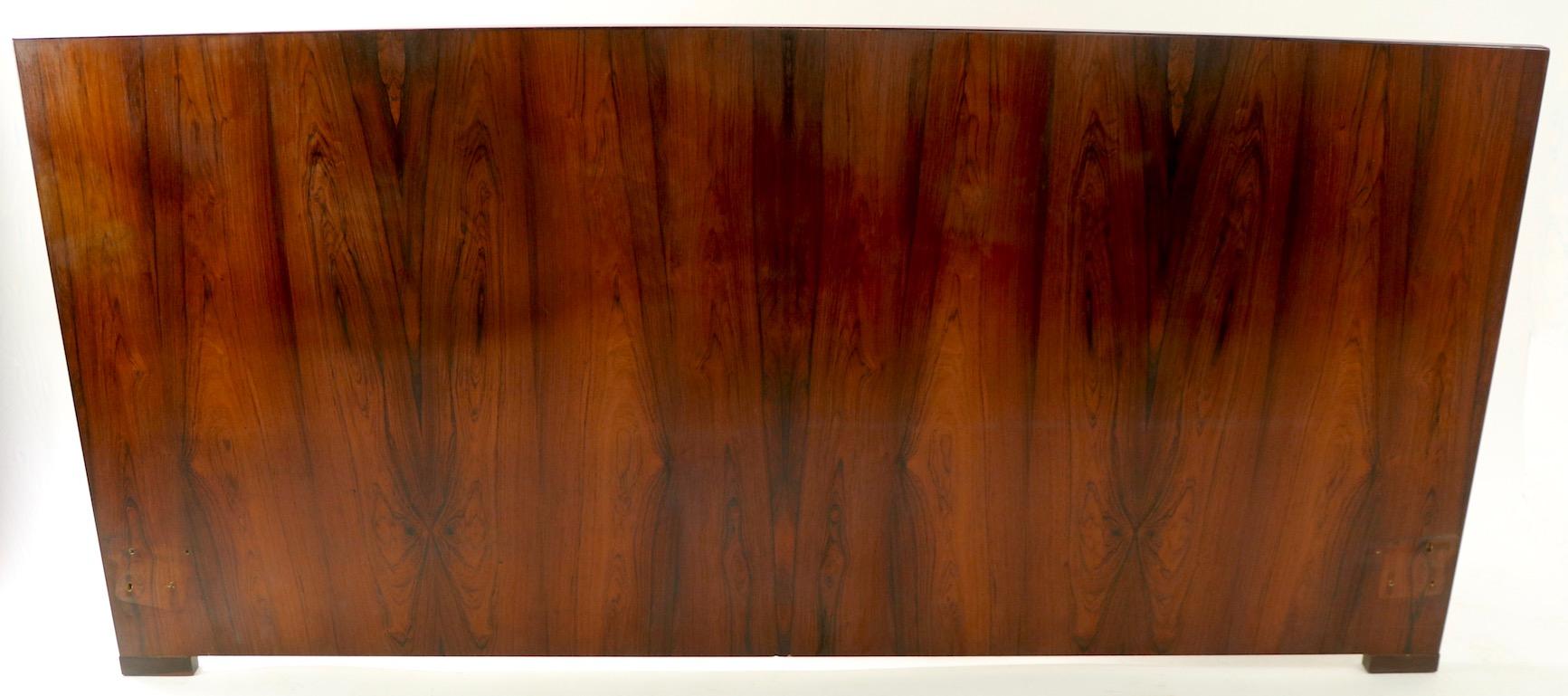 Stunning king size rosewood headboard by Dyrlund. Hard to find the large size headboards, especially in rosewood. This example has a slight warp to the board, however once attached ton you bed frame it is inconsequential - please see images.