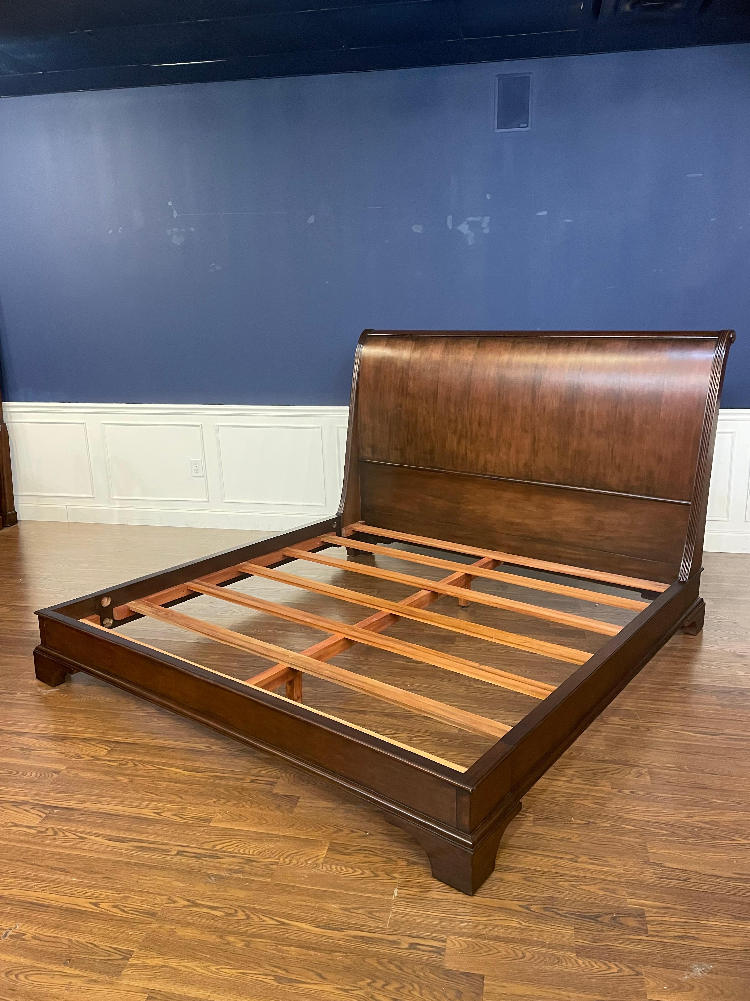 This is a traditional king size mahogany Sleigh Bed with a low footboard design by Leighton Hall Furniture.  It features a classic serpentine headboard.  It has a medium brown mahogany stain with a satin finish.  It has been used approximately six