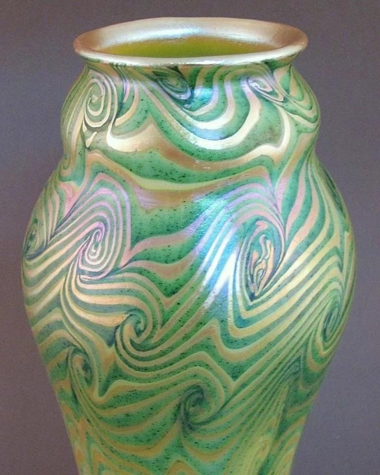 This is an exceptional quality art glass vase in the popular King Tut pattern of trailing swirls. It is from the estate of a second generation art glass collector in Eastern Oregon, her notes indicate this was added to her collection in the 1950s as