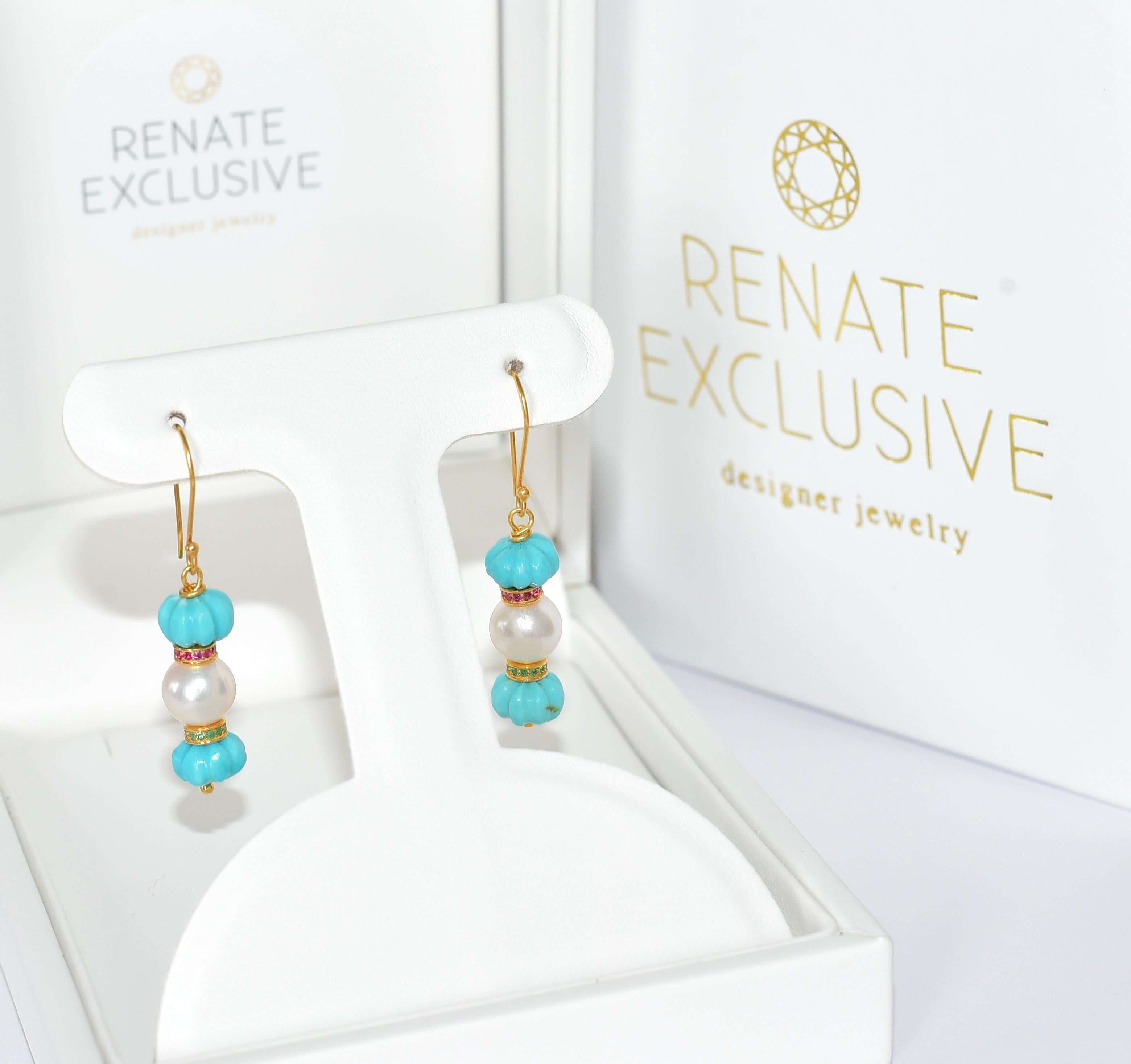 These precious unique and luxurious earrings were created from Kingman Turquoise and look at the fun part because they look like melons! The earring strikes a special shine with an 18K solid Yellow Gold multi-color Eternity bead with natural Ruby