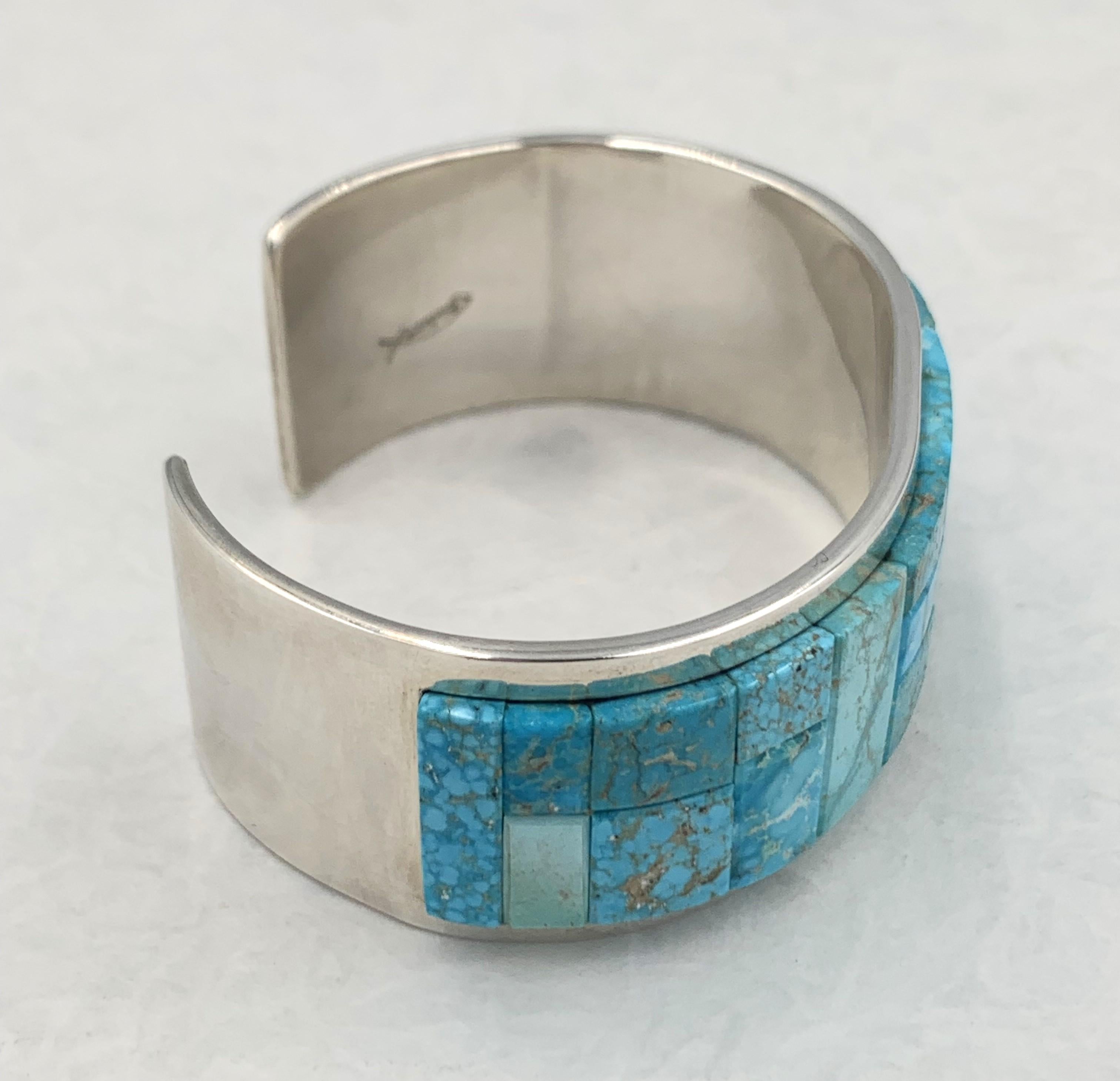 Sterling silver raised inlay turquoise cuff by master silversmith Tommy Jackson. The 1” cuff has Kingman turquoise inlay. The inside measurement is 6” with a 1” gap.

The Kingman Turquoise Mine is one of the oldest producing Turquoise mines in North