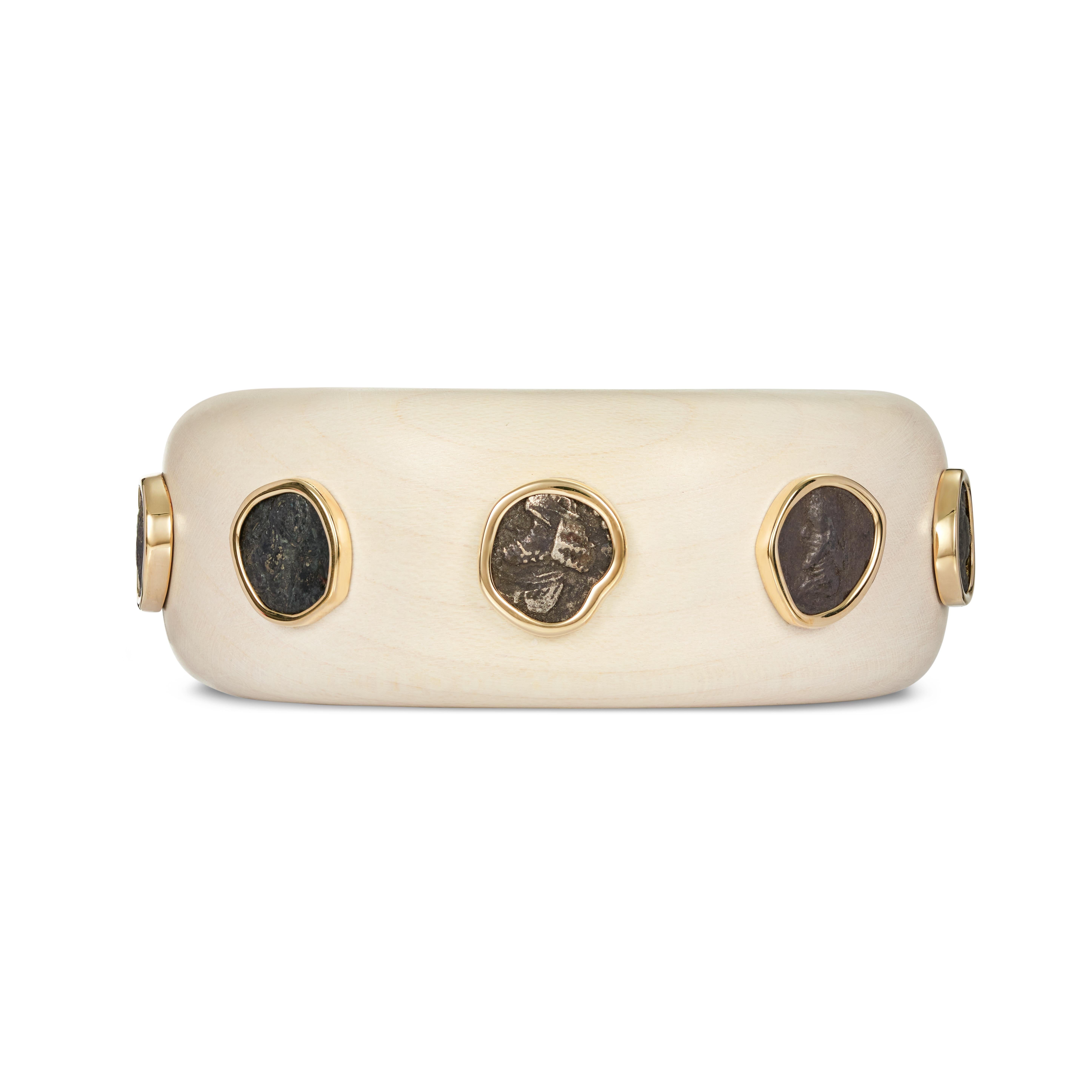 This DUBINI coin bracelet from the 'Empires' collection features an authentic hemidrachm coins of Kings of Persis circa 1st century B.C. set in 18kt yellow gold on maple wooden bracelet.   

* Each piece is provided with a certificate of