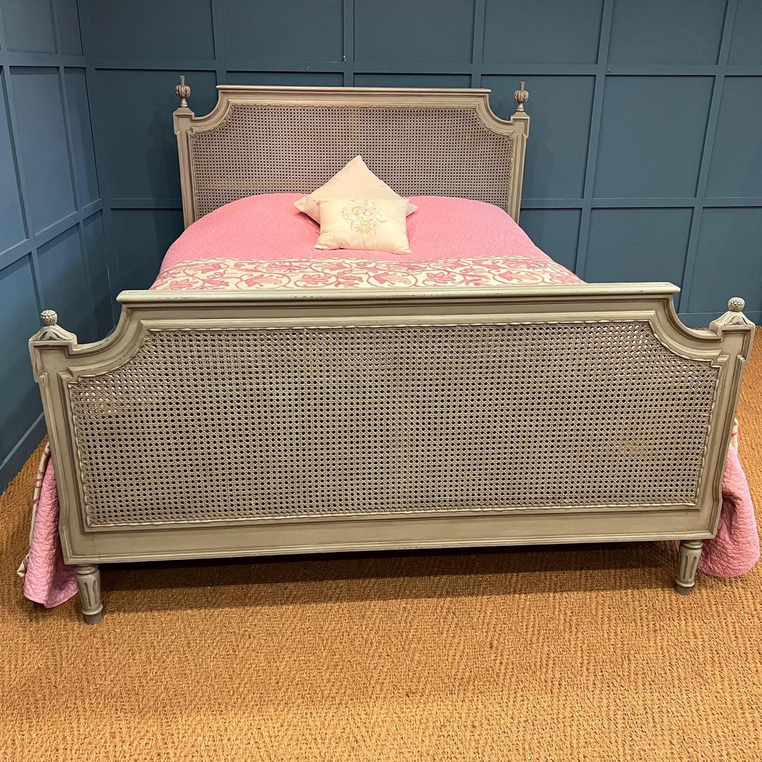 This attractive king size (5’wide) vintage cane bedframe originates from France.. The frame is painted in its original grey/green paint and shows some sign of wear in places due to its age – it has a slightly distressed look to it. The cane is in