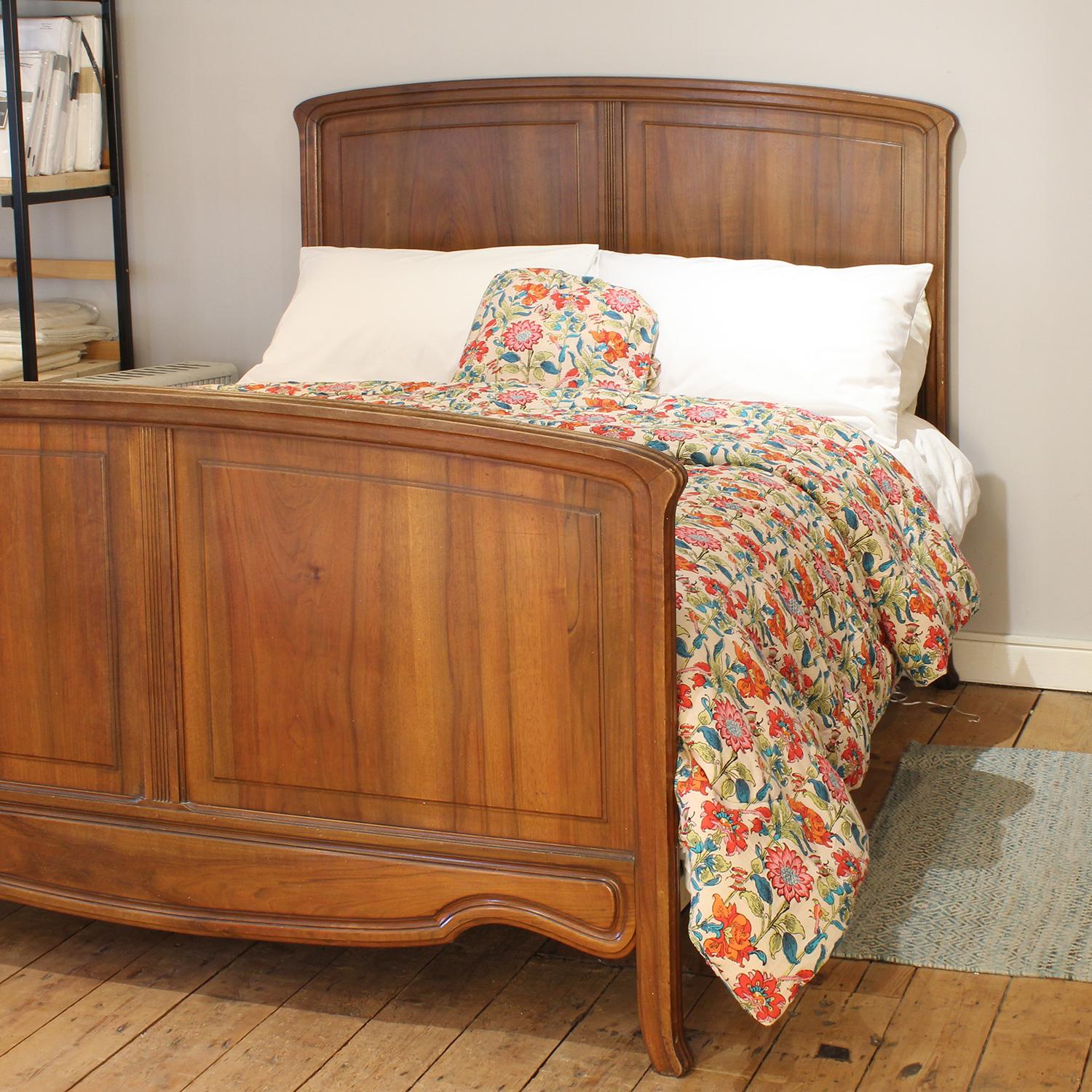 An attractive walnut bedstead in the Art Nouveau style with simple curved top panels.

This bed accepts a kingsize, 5ft (60 in), base and mattress set.

The price is for the bed frame and a firm bed base. 

The mattress, sprung bed base,