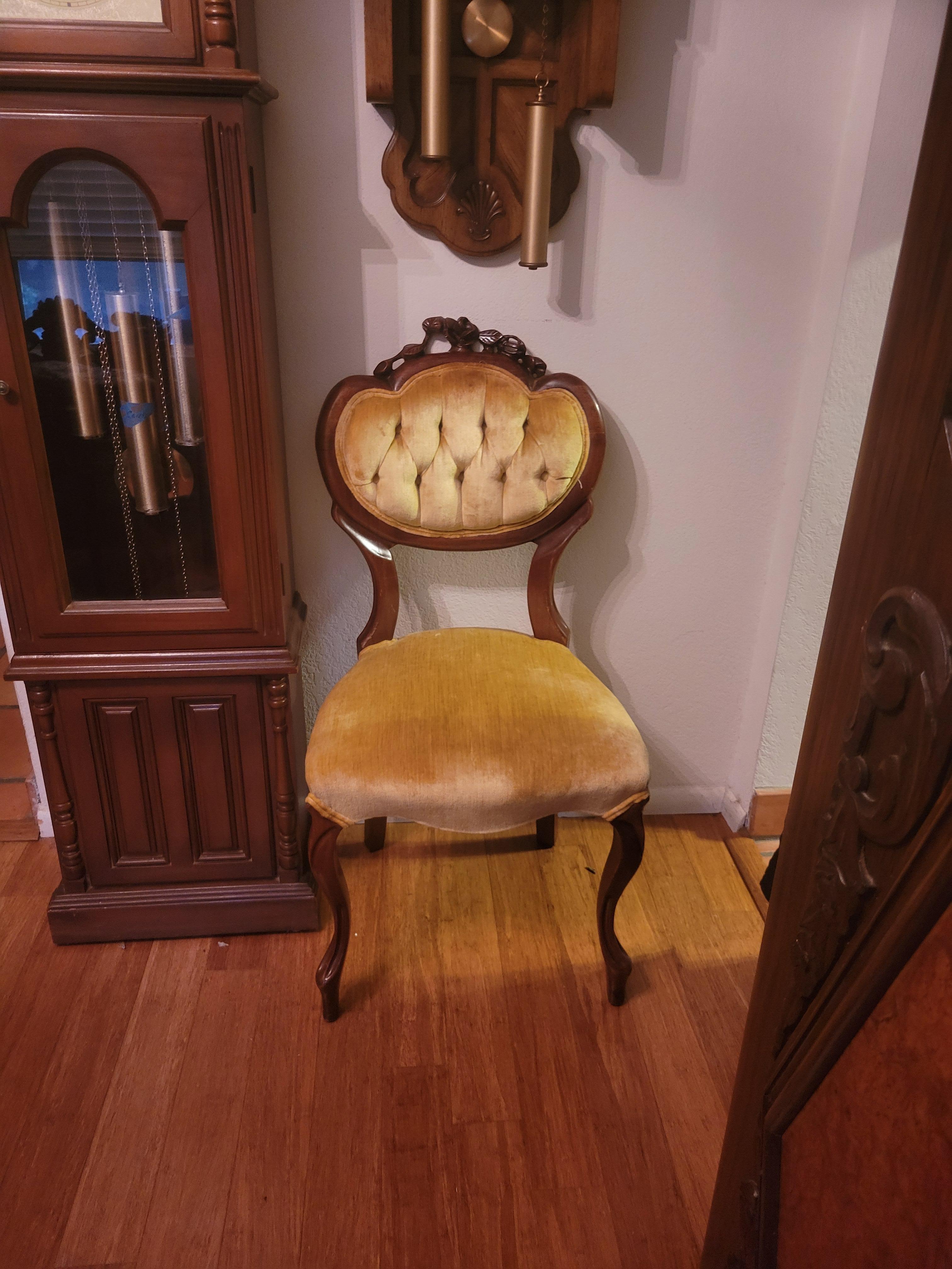 Kimball Reproductiond solid wood hand-carved Victorian chair. The chair is very sturdy and has an original upholstery. The front and the seat have no rips or other damages. The upholstery on the back of the chair has a little fraying on the trim.