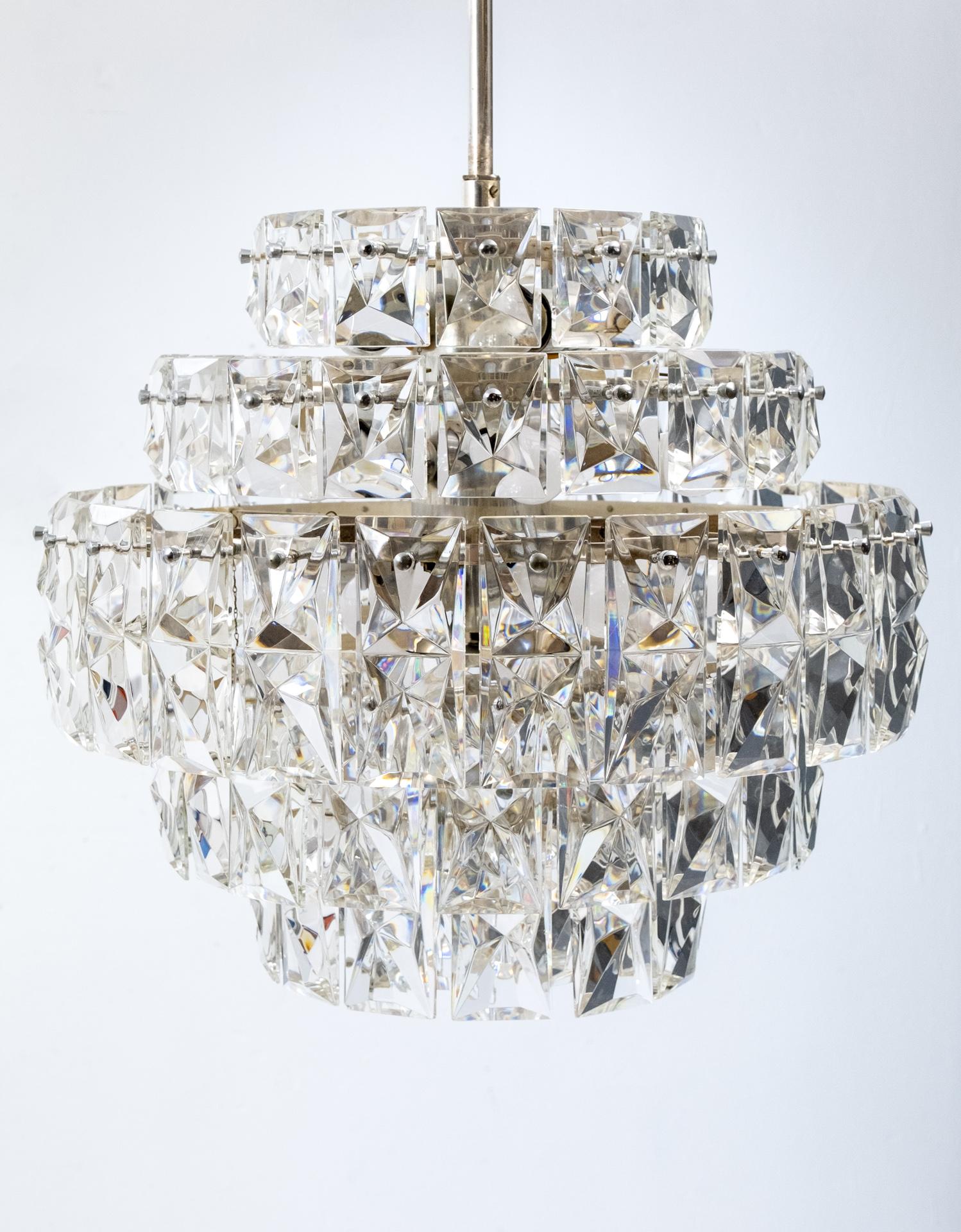 Very impressive 6 tiered Chrystal chandelier by Kinkeldey Germany a prestigious manufacturer of lighting 1970s. Chrome base comes with 100 faceted crystals. 16 E40 bulbs Led lamps can be used.
Art Deco style. Some of the crystals have chips.