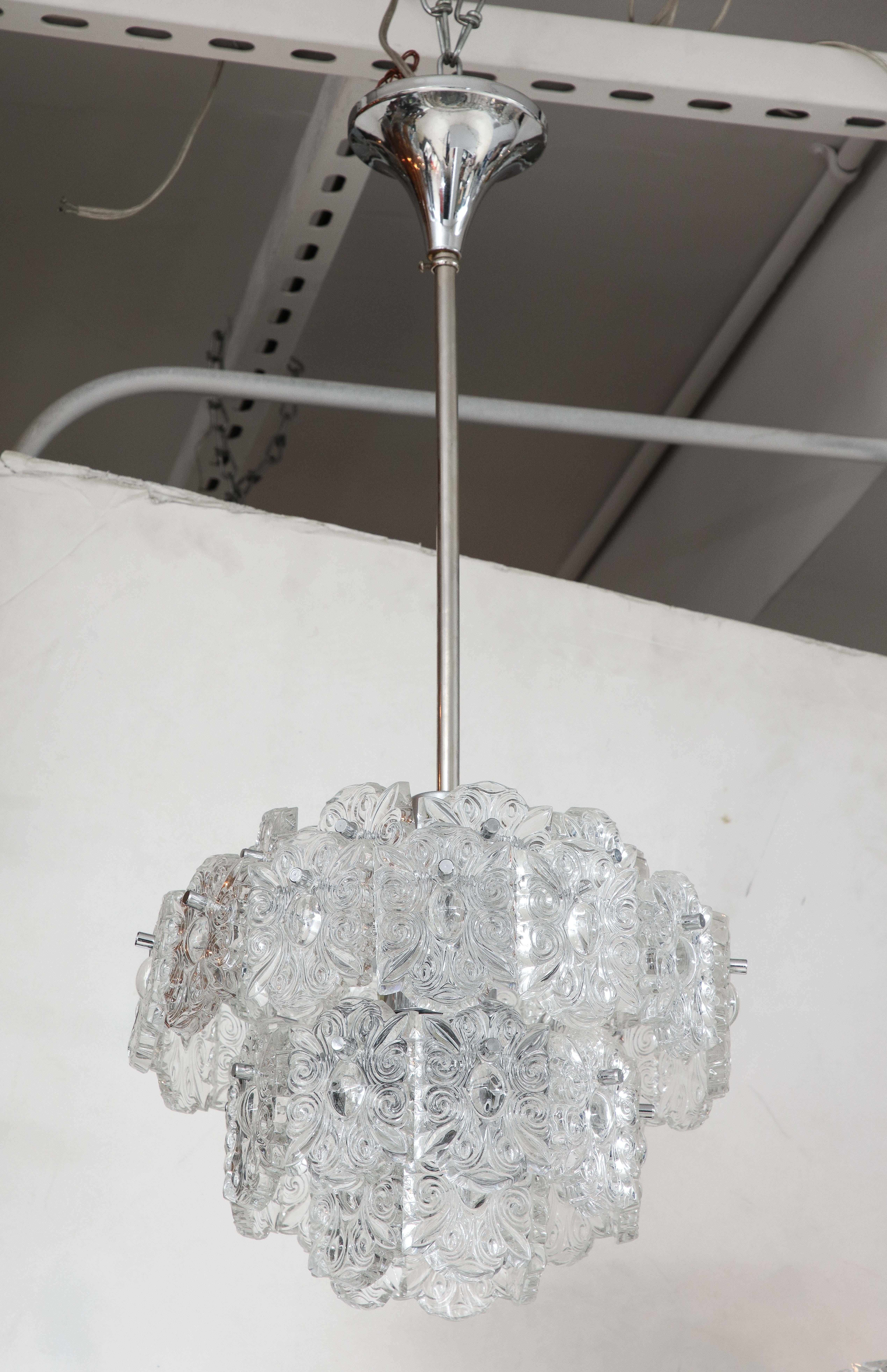 Scandinavian Modern 4 tier chandelier featuring oblong stylized cameo cystals suspended from a polished nickel frame and canopy. Rewired for use in the USA, 7 sockets.